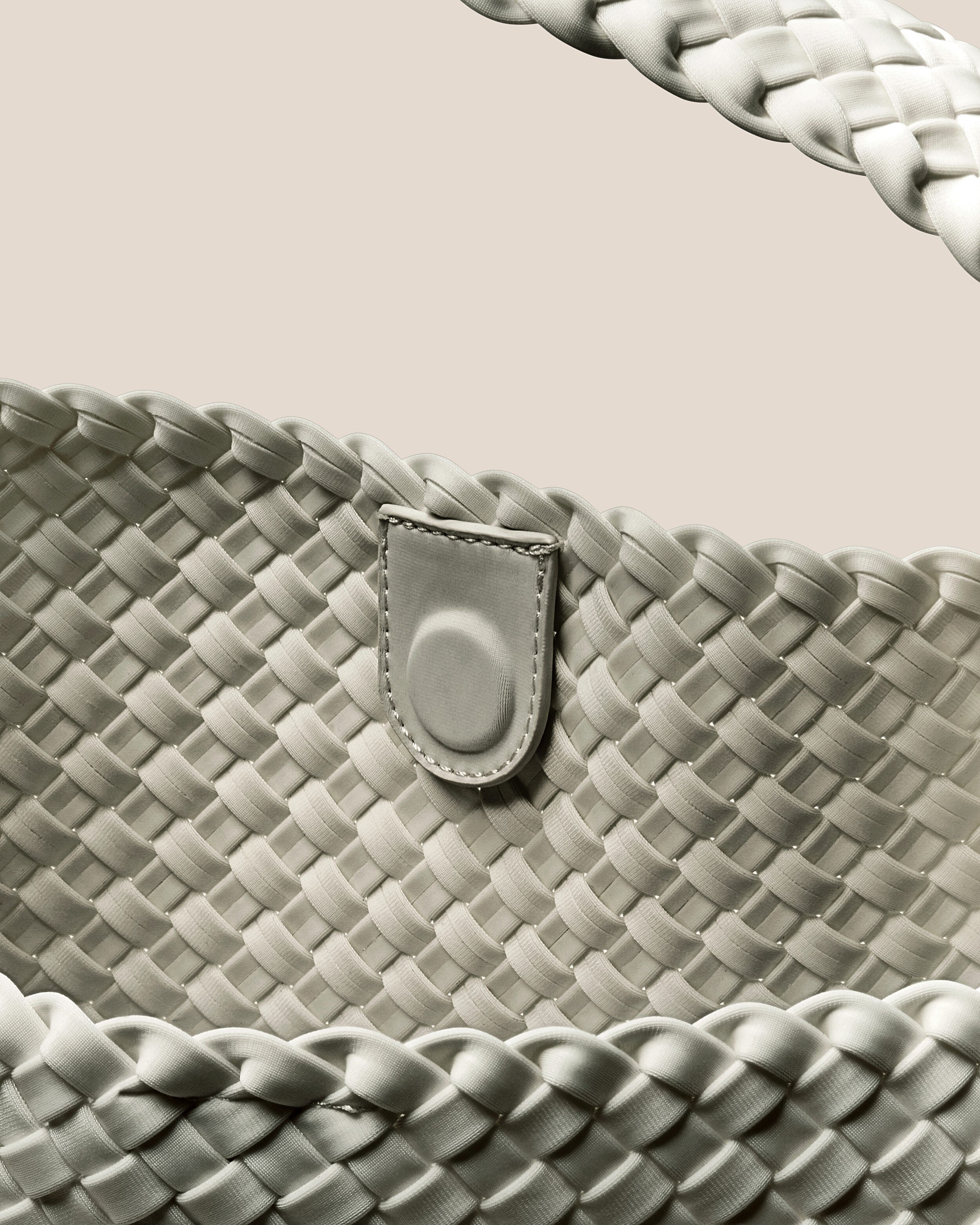 Interior close-up of Nomad Hobo in Celadon showing its open top with magnetic snap closure, and unlined interior.