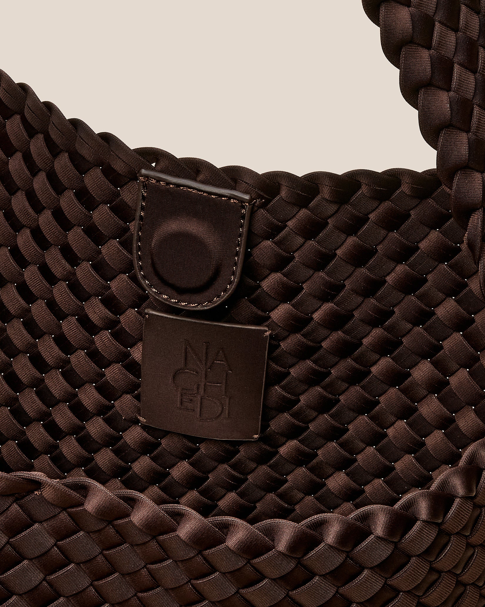 Interior close-up of Nomad Medium Hobo Bag in Chocolate showing its open top with magnetic snap closure, and unlined interior.