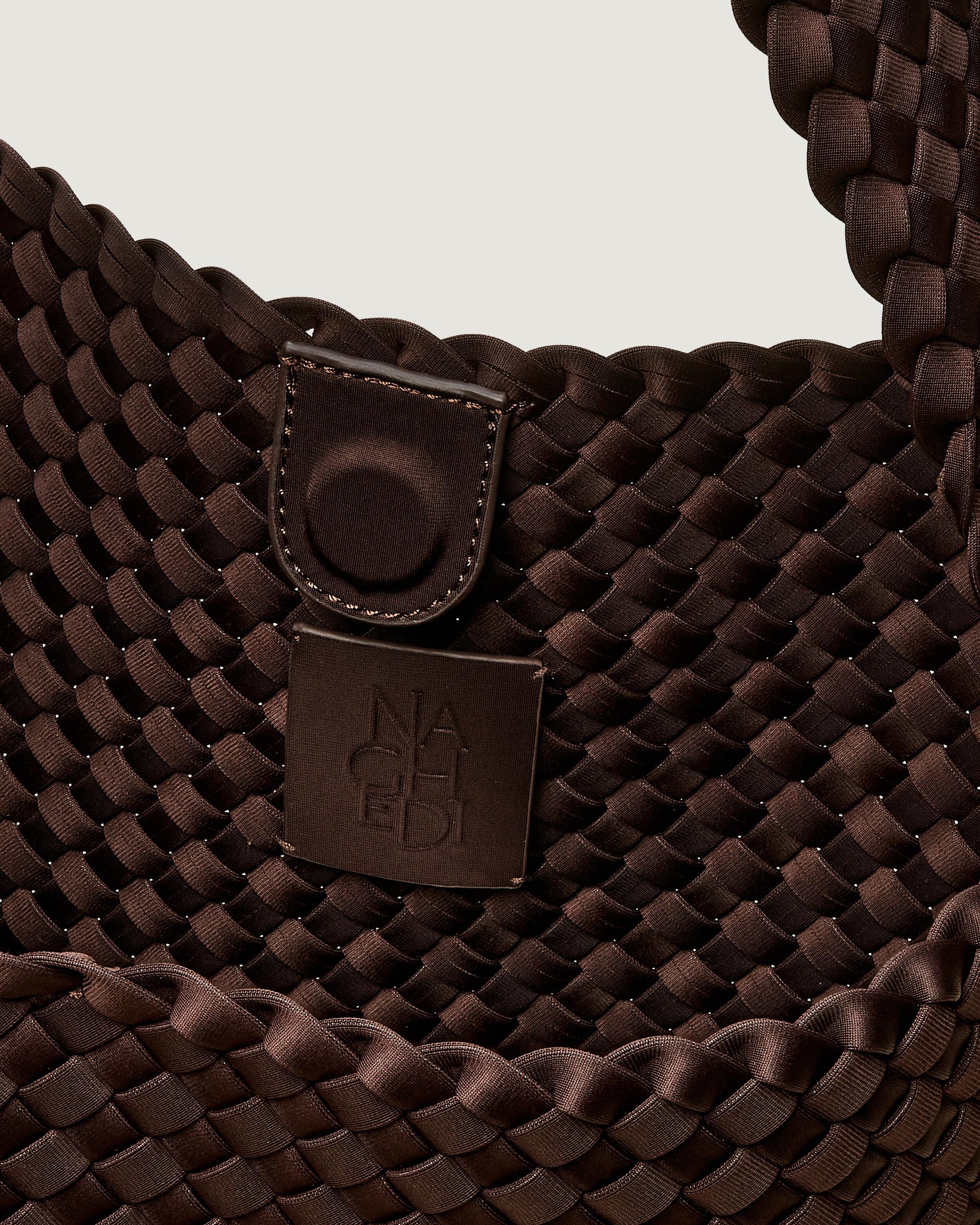 Interior close-up of Nomad Hobo in Chocolate showing its open top with magnetic snap closure, and unlined interior.