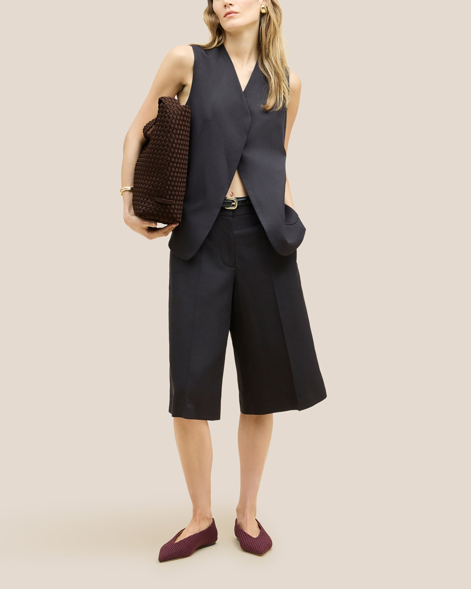 Nomad Medium Hobo Bag in Chocolate shown on model to illustrate scale and soft silhouette.