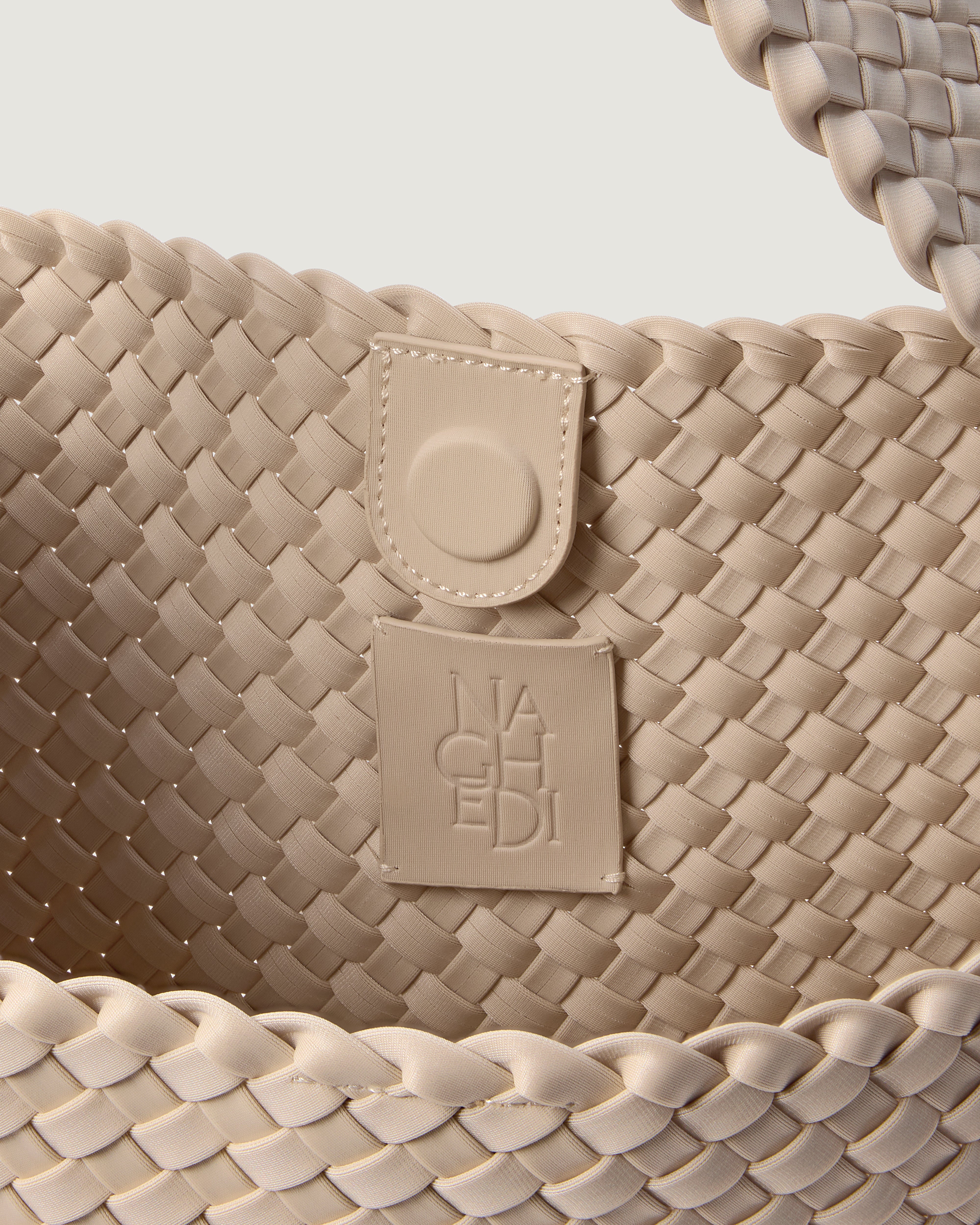 Interior close-up of Nomad Hobo in Ecru showing its open top with magnetic snap closure, and unlined interior.
