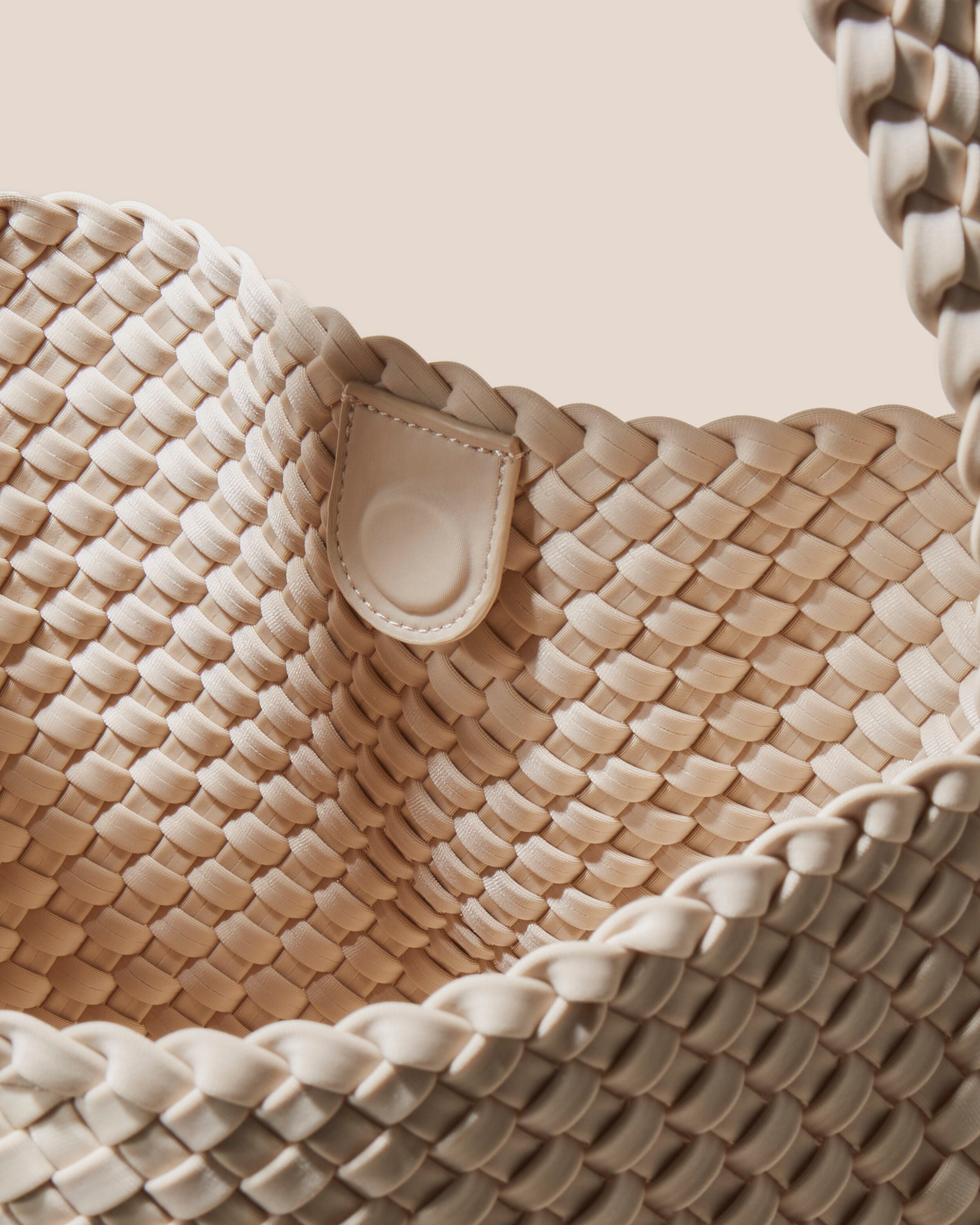 Interior close-up of Nomad Hobo in Ecru showing its open top with magnetic snap closure, and unlined interior.