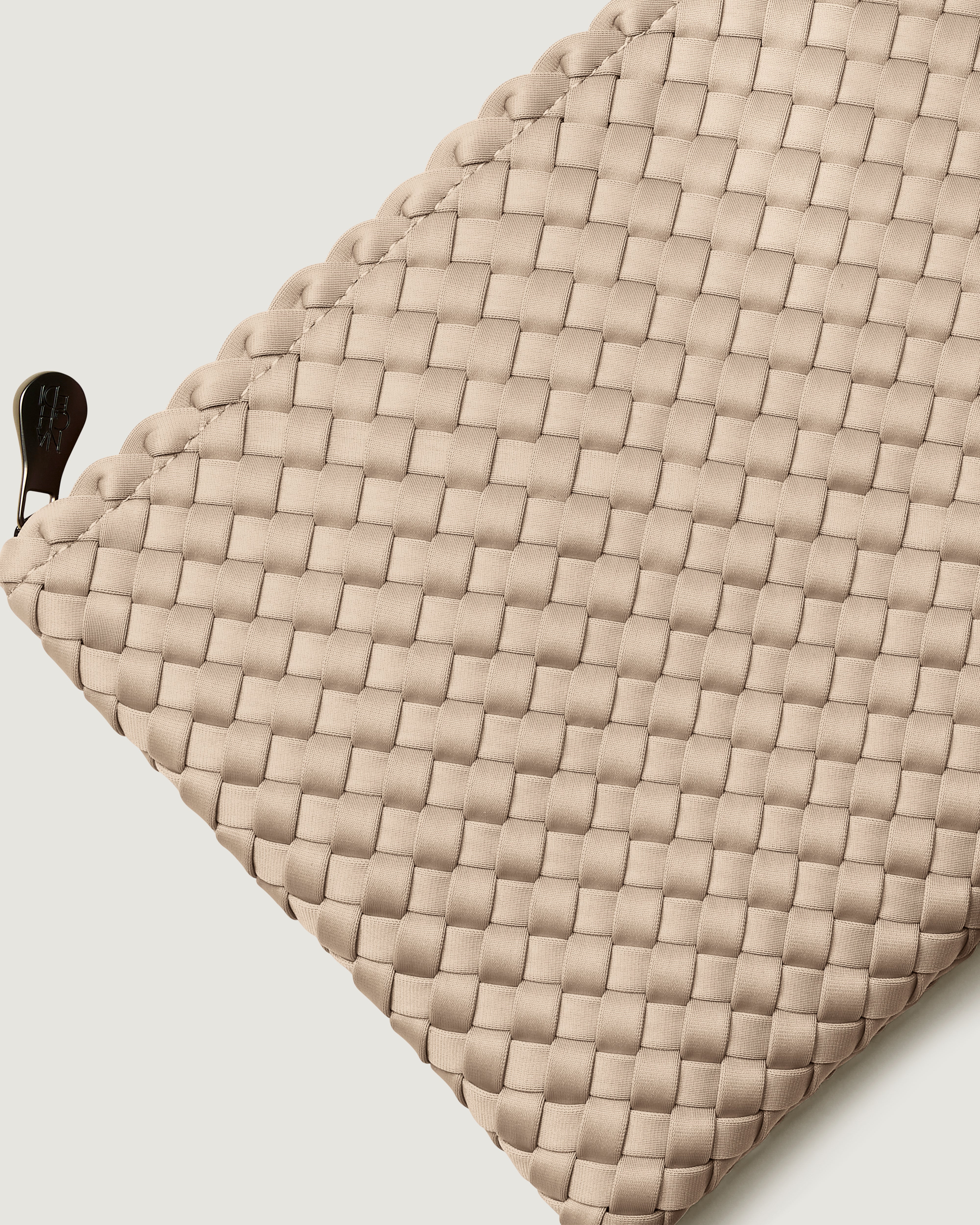 Close-up of included matching woven zippered pouch.