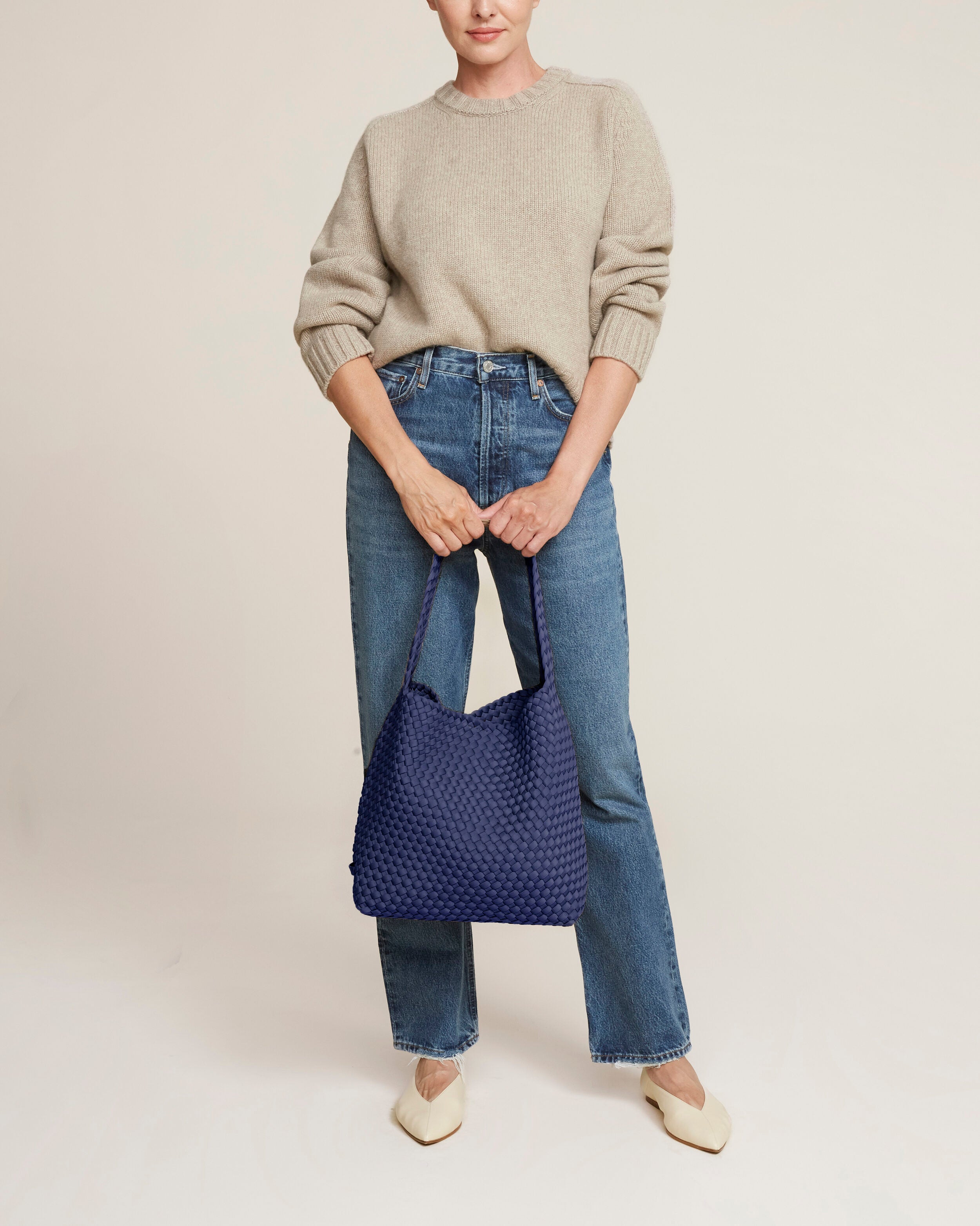 Nomad Hobo in Ink Blue shown on model to illustrate scale and soft silhouette.