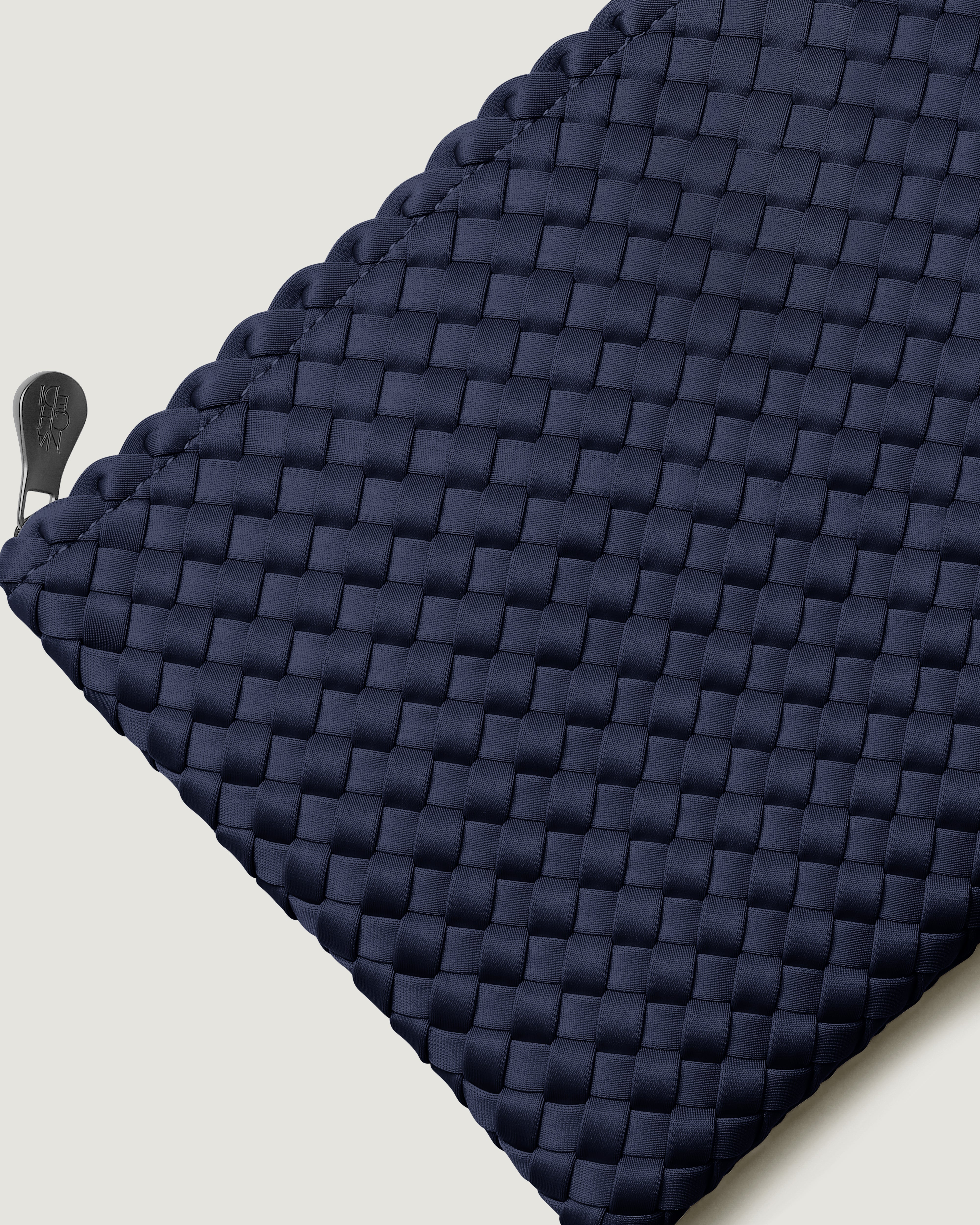 Close-up of included matching woven zippered pouch.