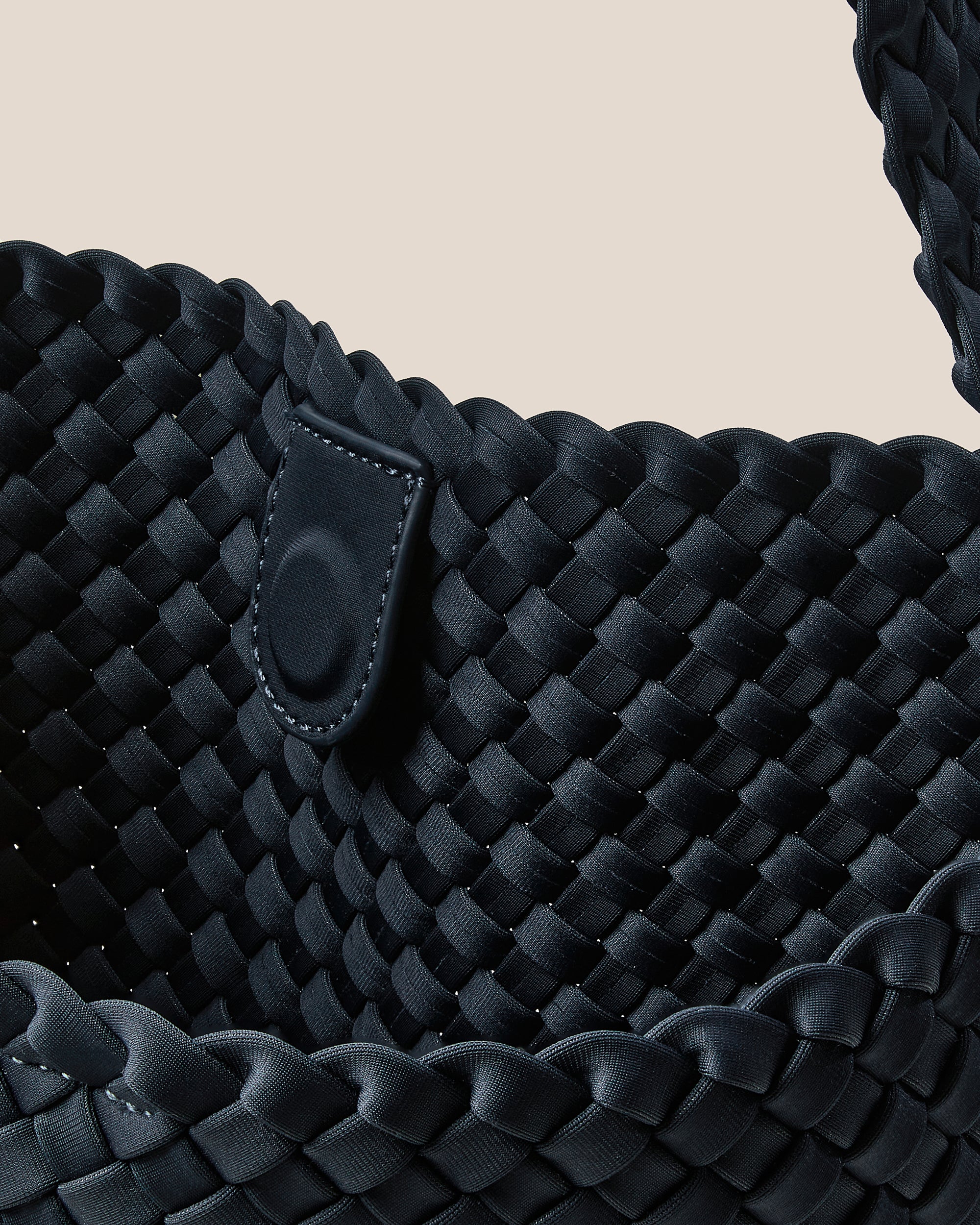 Interior close-up of Nomad Hobo in Murano showing its open top with magnetic snap closure, and unlined interior.