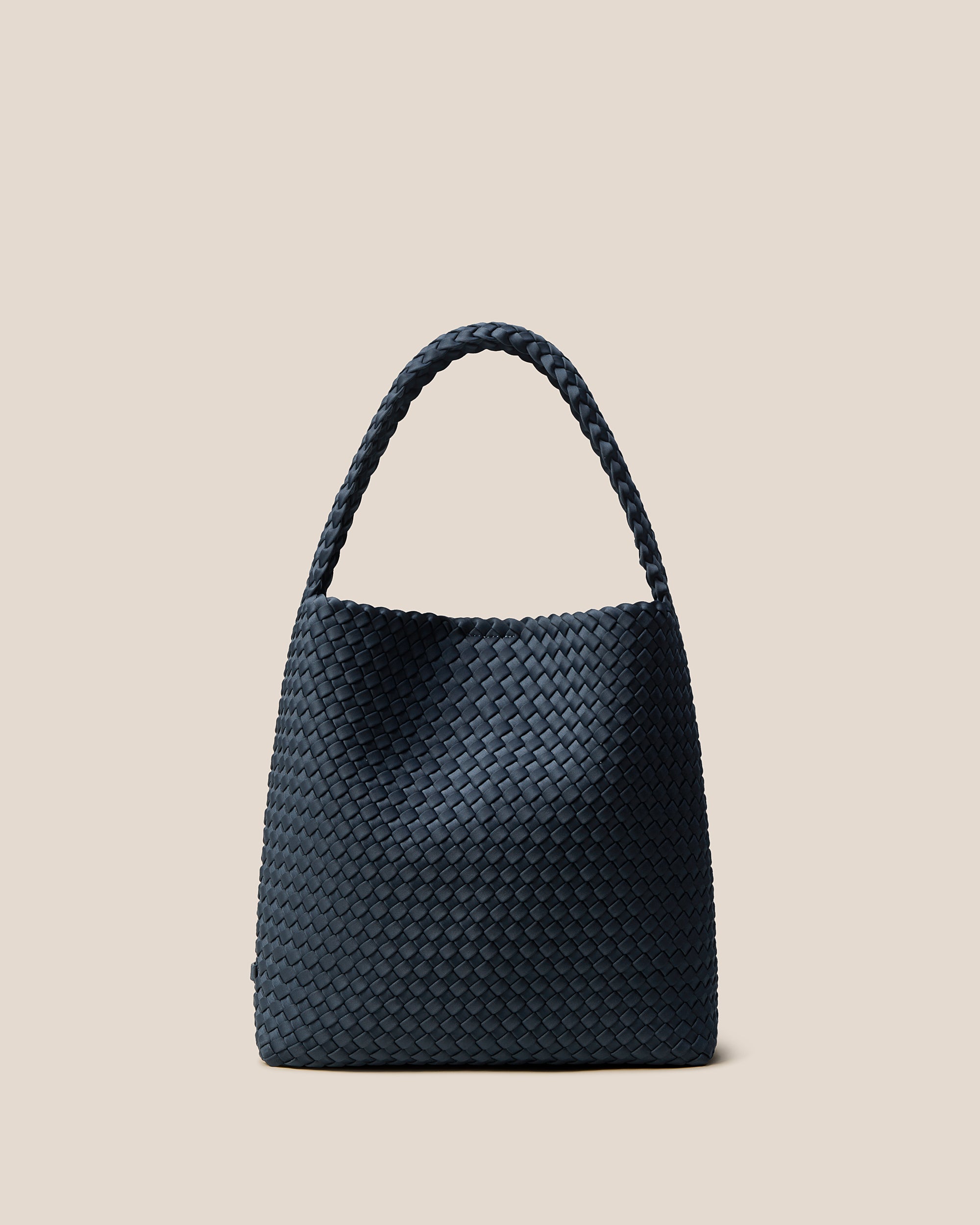 Nomad Hobo in Murano, a midnight teal blue tone, in handwoven neoprene, featuring an open top with magnetic snap closure, and handwoven shoulder strap lays comfortably flat.