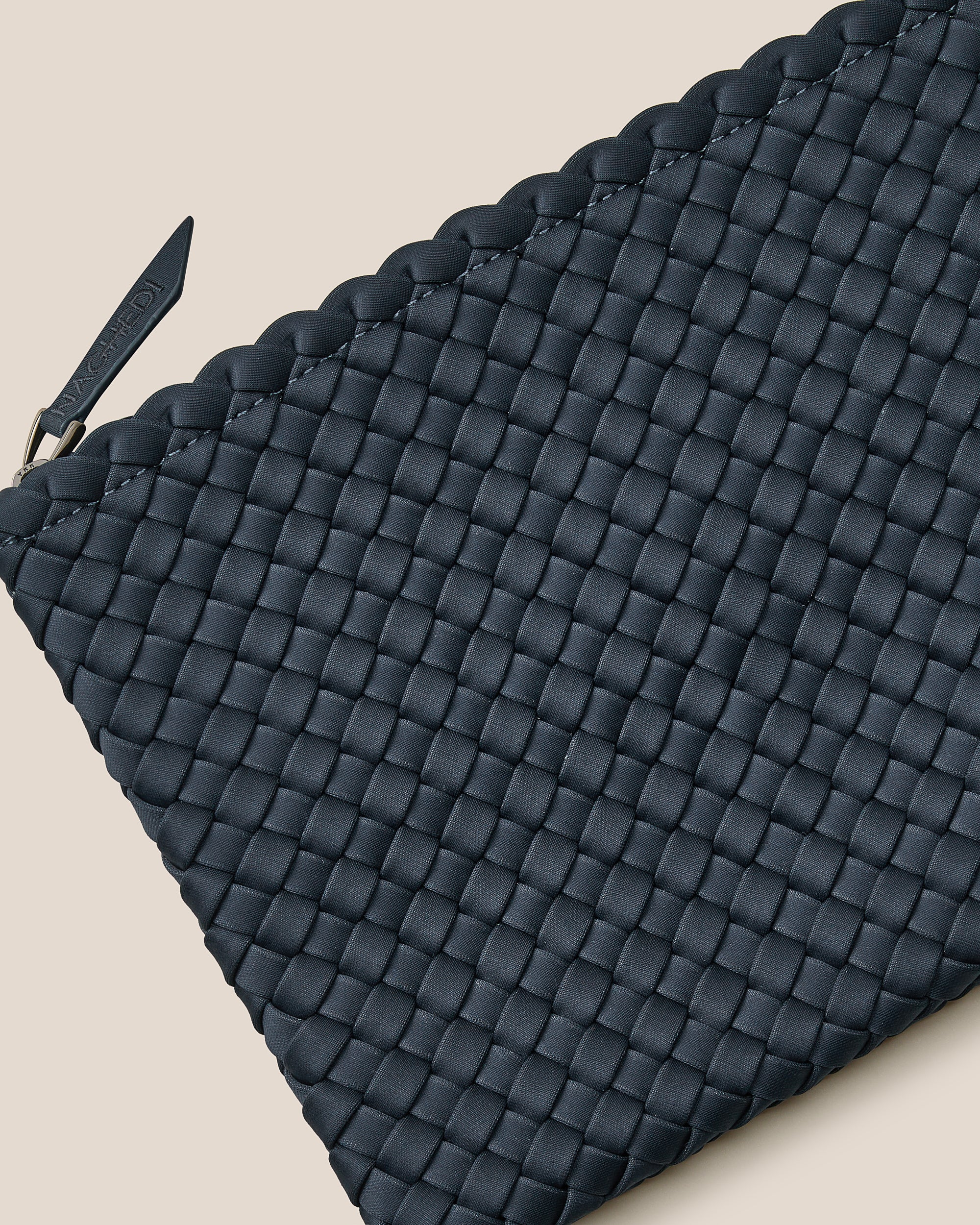 Close-up of included matching woven zippered pouch.