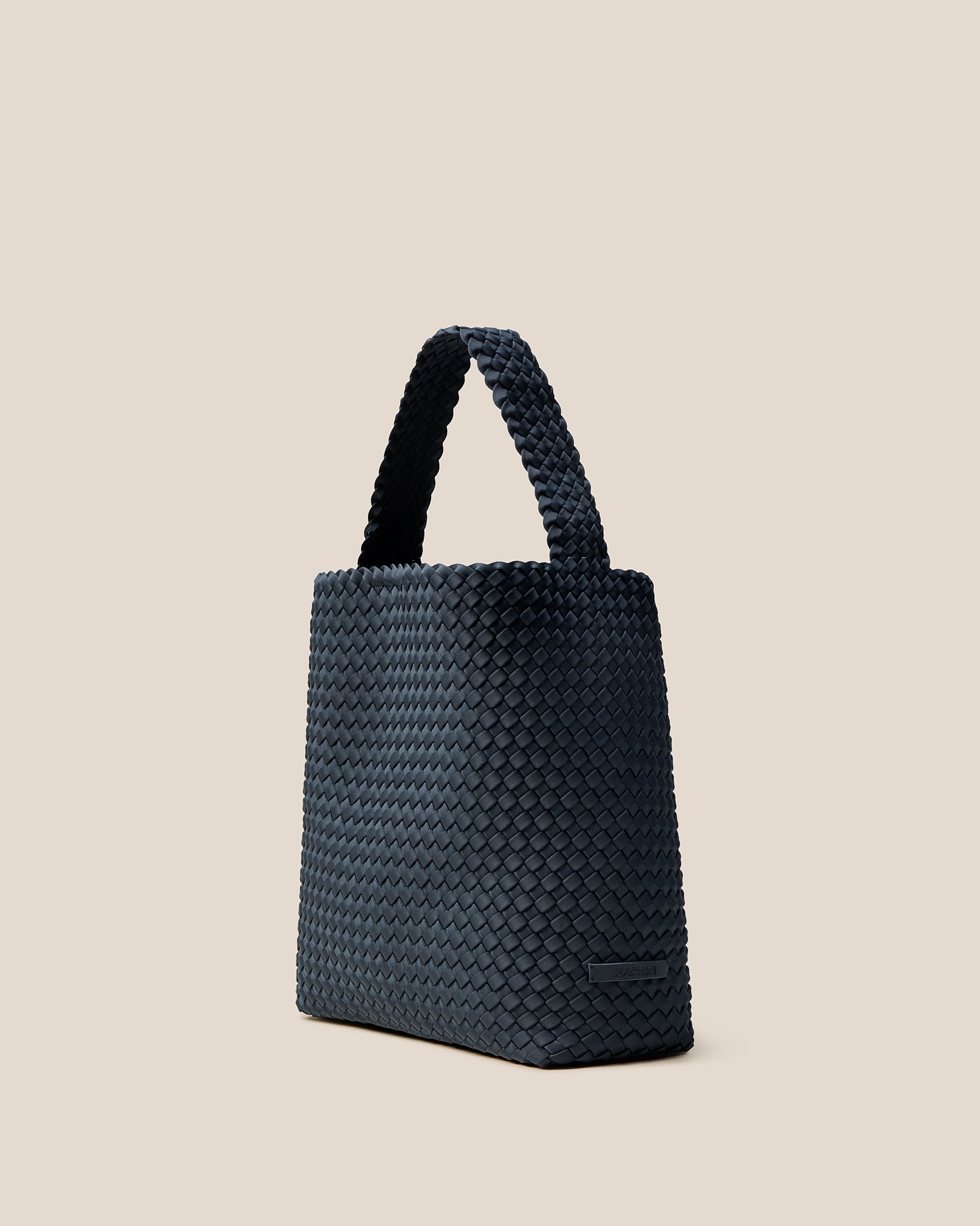 Nomad Hobo in Murano shown from a side angle, highlighting its handwoven neoprene construction and open top with magnetic snap closure.