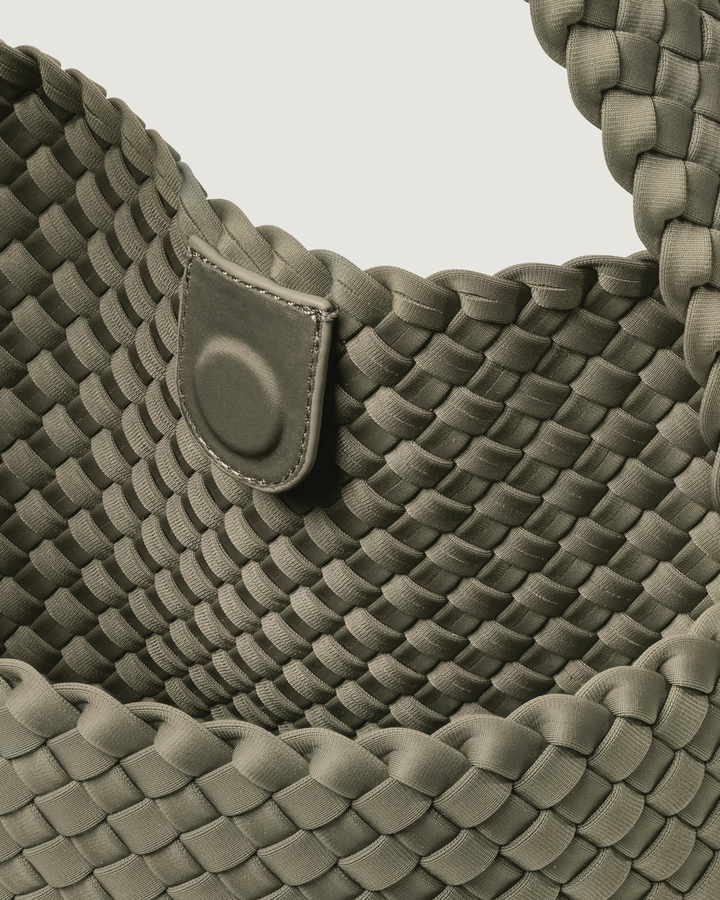 Interior close-up of Nomad Hobo in Olea showing its open top with magnetic snap closure, and unlined interior.