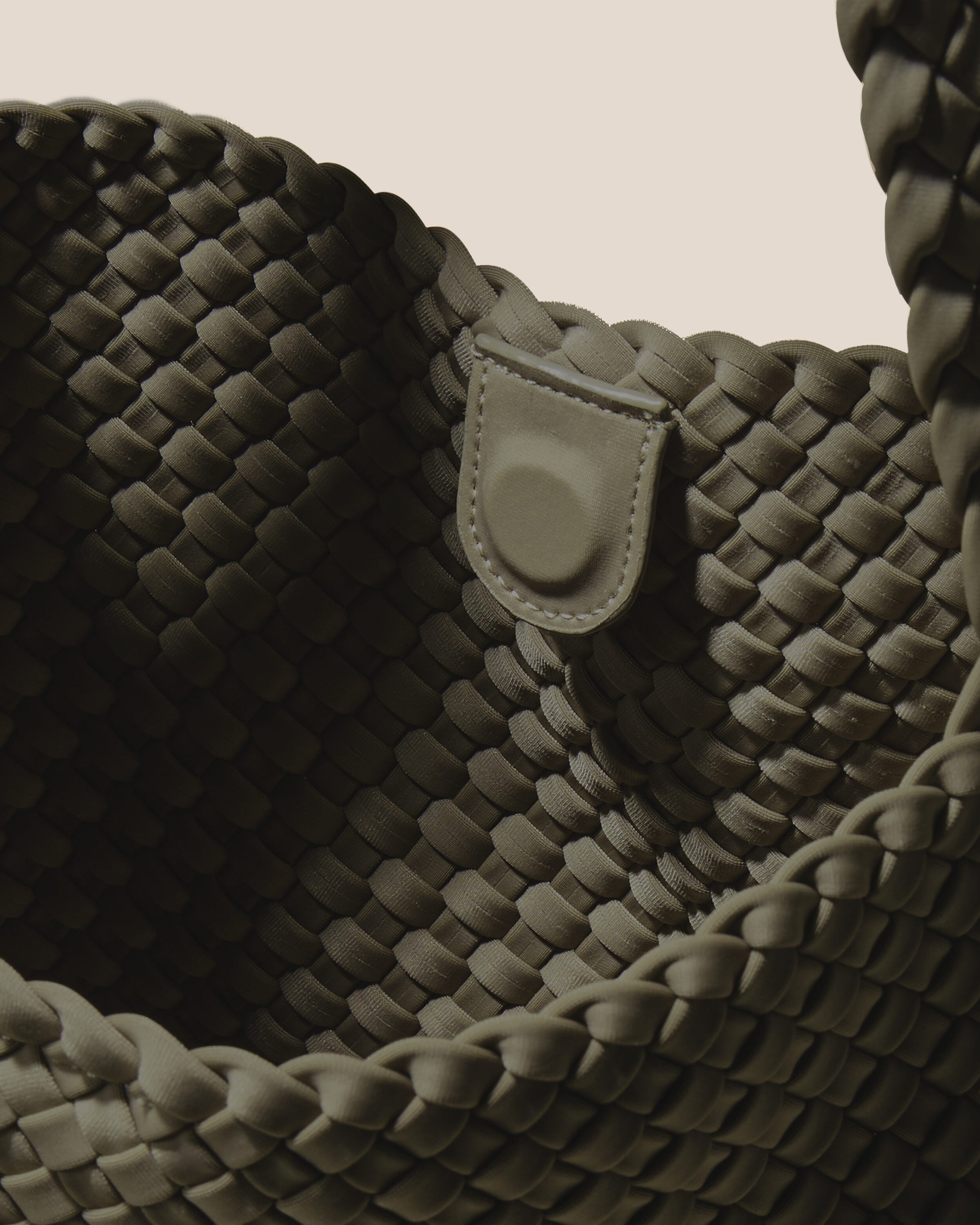 Interior close-up of Nomad Hobo in Olive showing its open top with magnetic snap closure, and unlined interior.