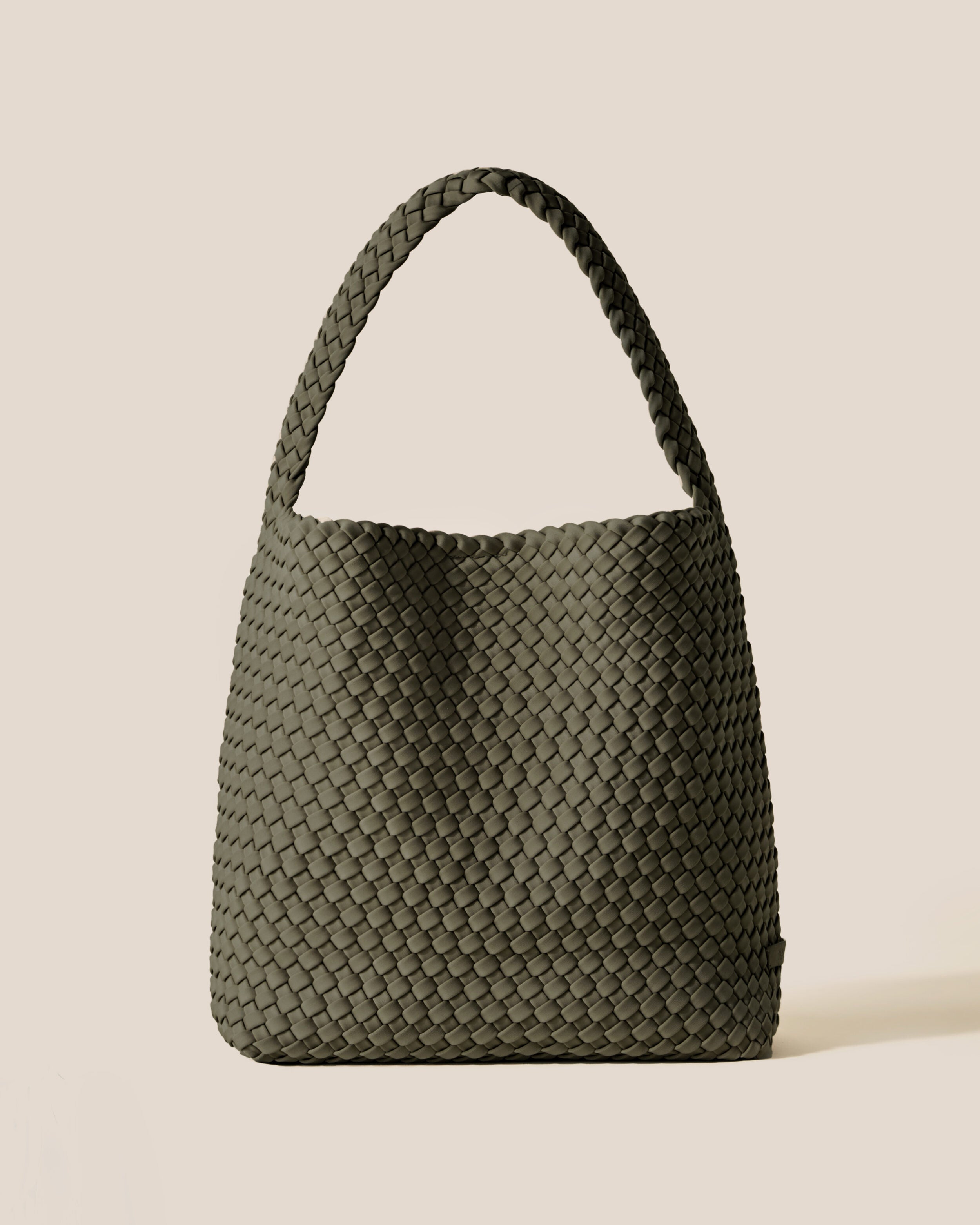 Nomad Hobo in Olive, an olive green tone, in handwoven neoprene, featuring an open top with magnetic snap closure, and handwoven shoulder strap lays comfortably flat.