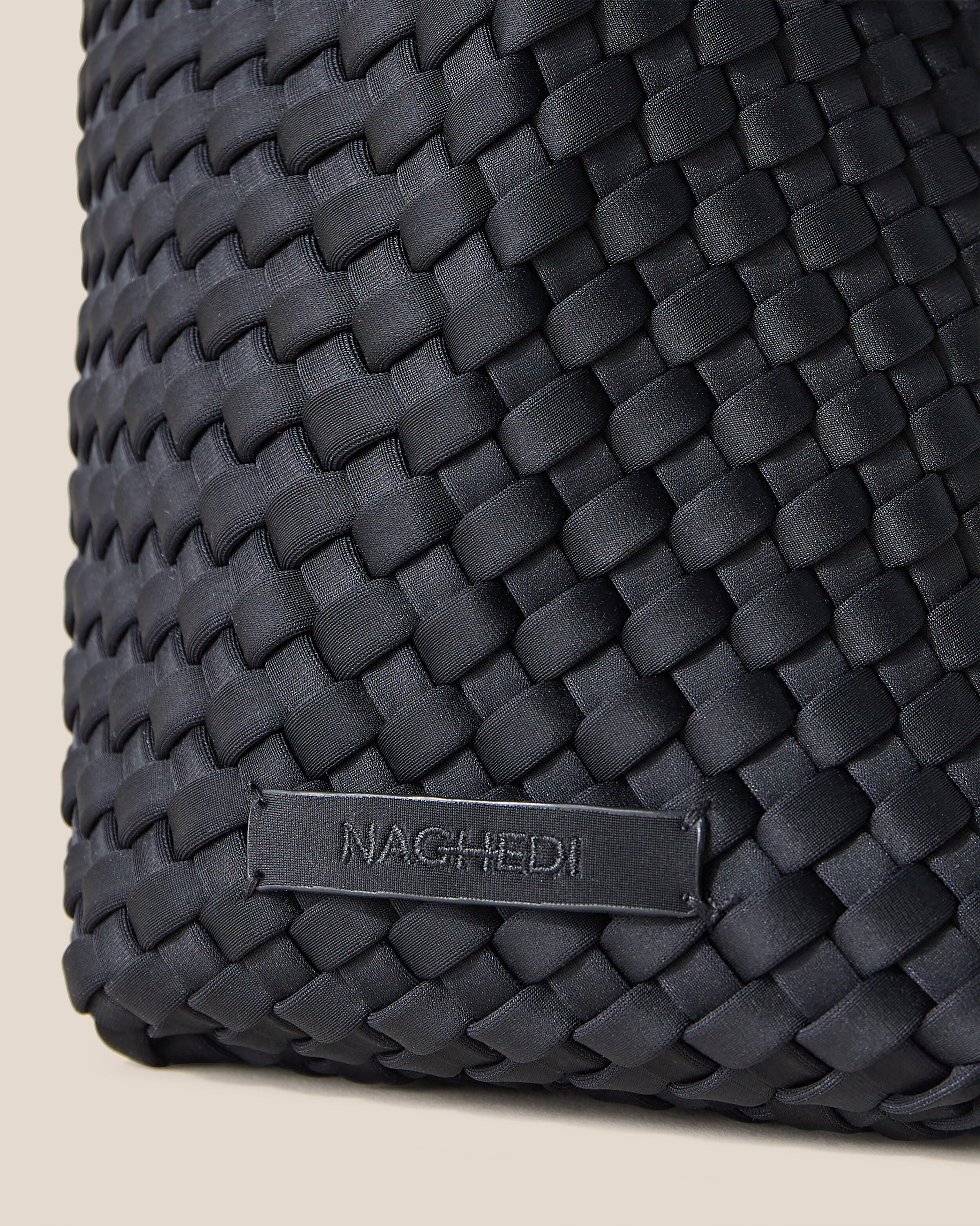 Close-up of stamped NAGHEDI logo on Nomad Hobo in Onyx.