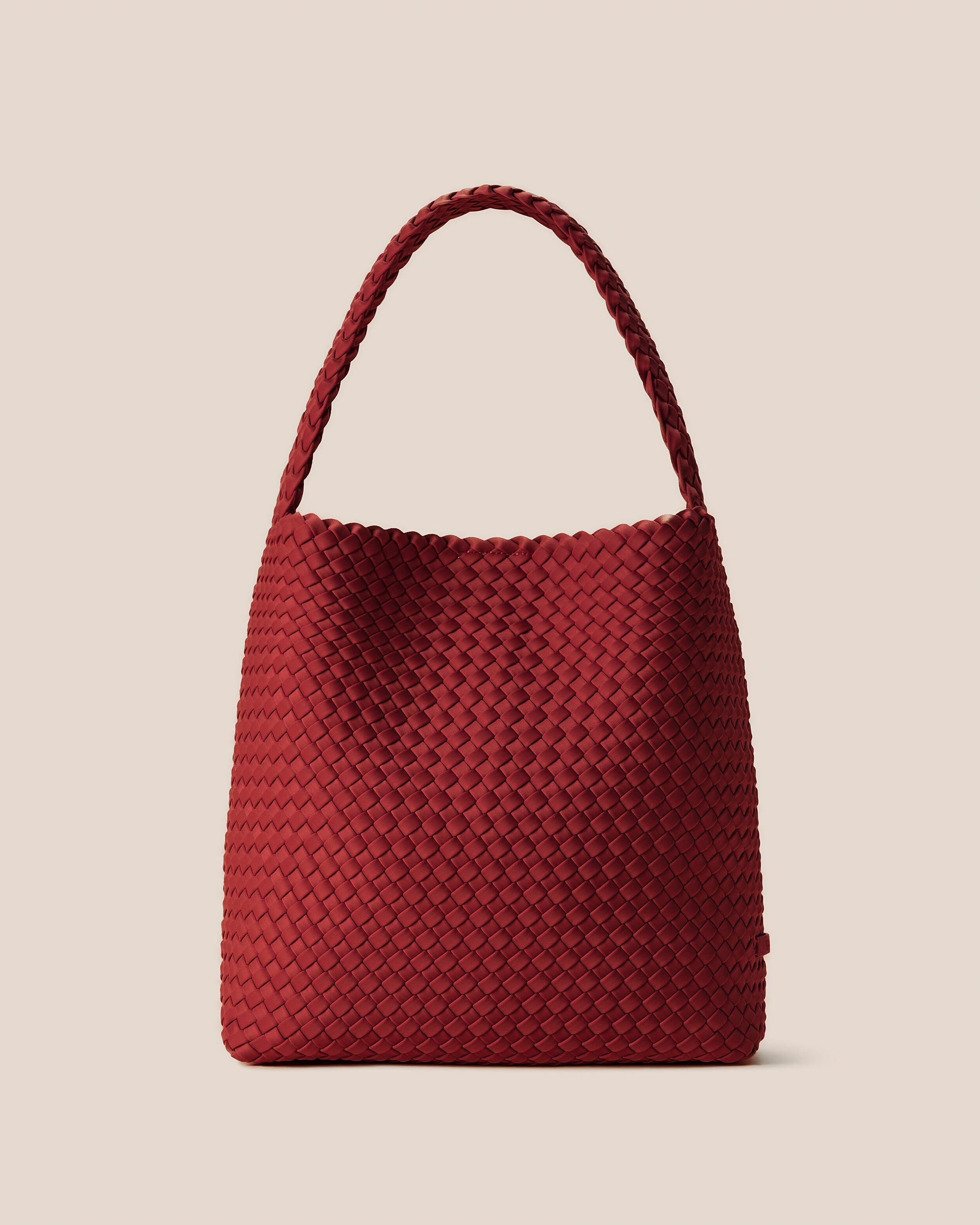 Nomad Hobo in Rosso, a rich red tone, in handwoven neoprene, featuring an open top with magnetic snap closure, and handwoven shoulder strap lays comfortably flat.