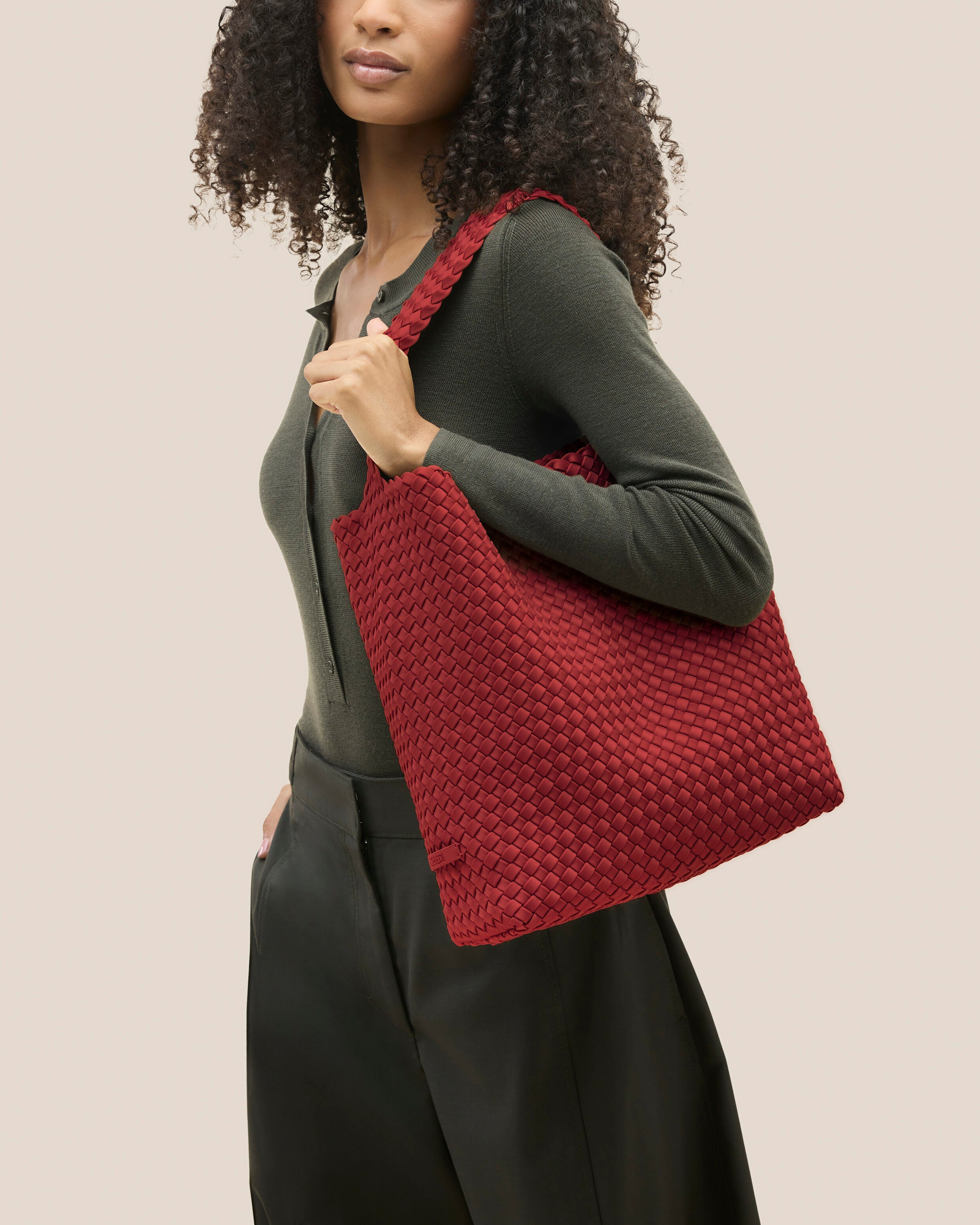Nomad Hobo in Rosso shown on model to illustrate scale and soft silhouette.