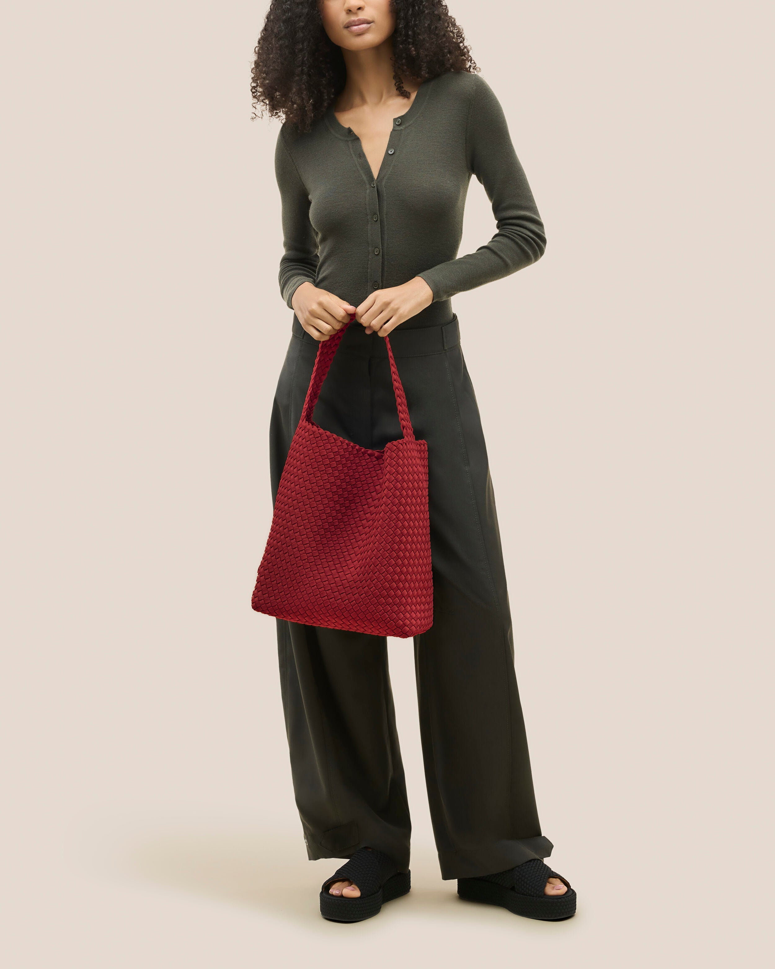 Nomad Hobo in Rosso shown on model to illustrate scale and soft silhouette.