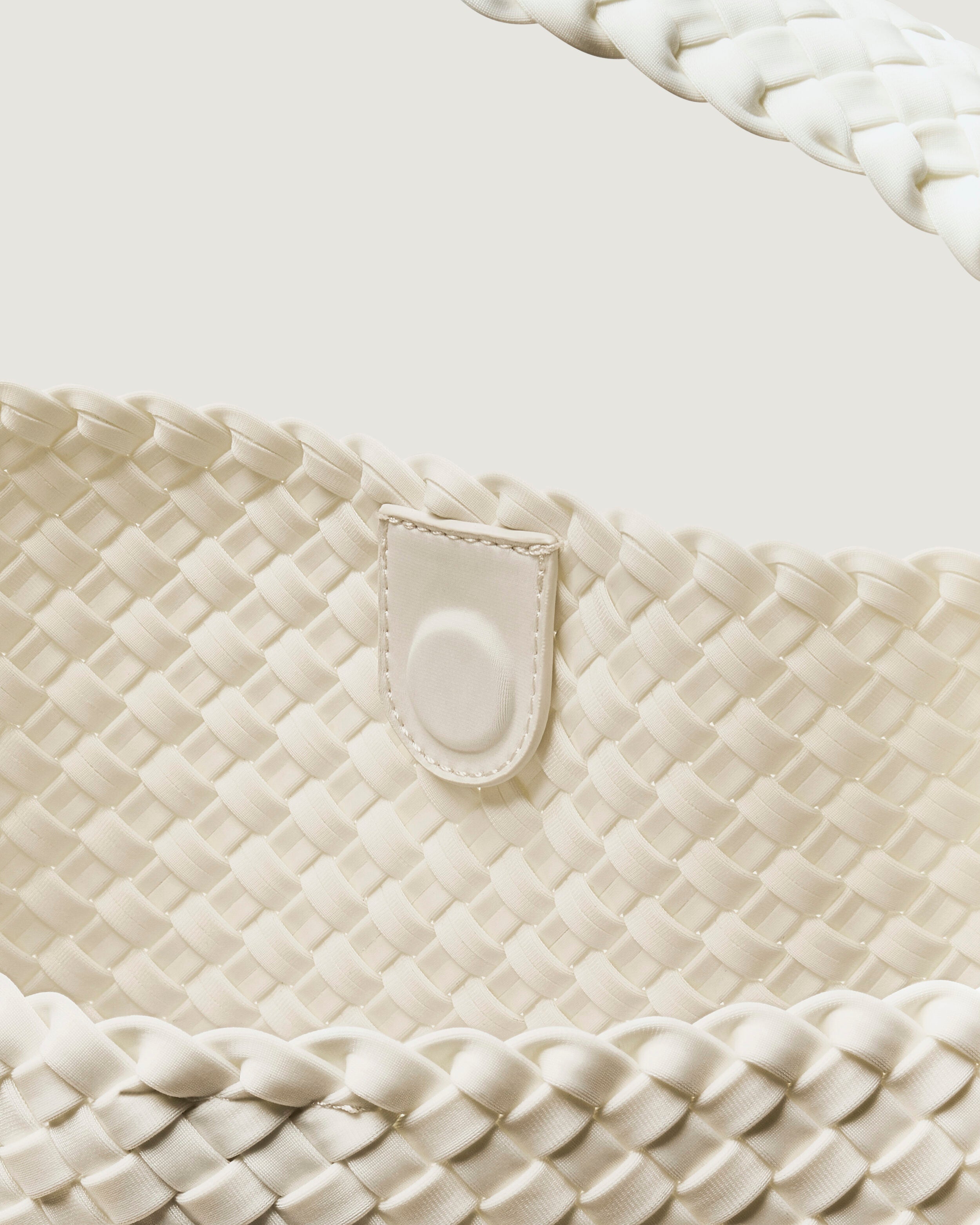 Interior close-up of Nomad Hobo in Salt showing its open top with magnetic snap closure, and unlined interior.