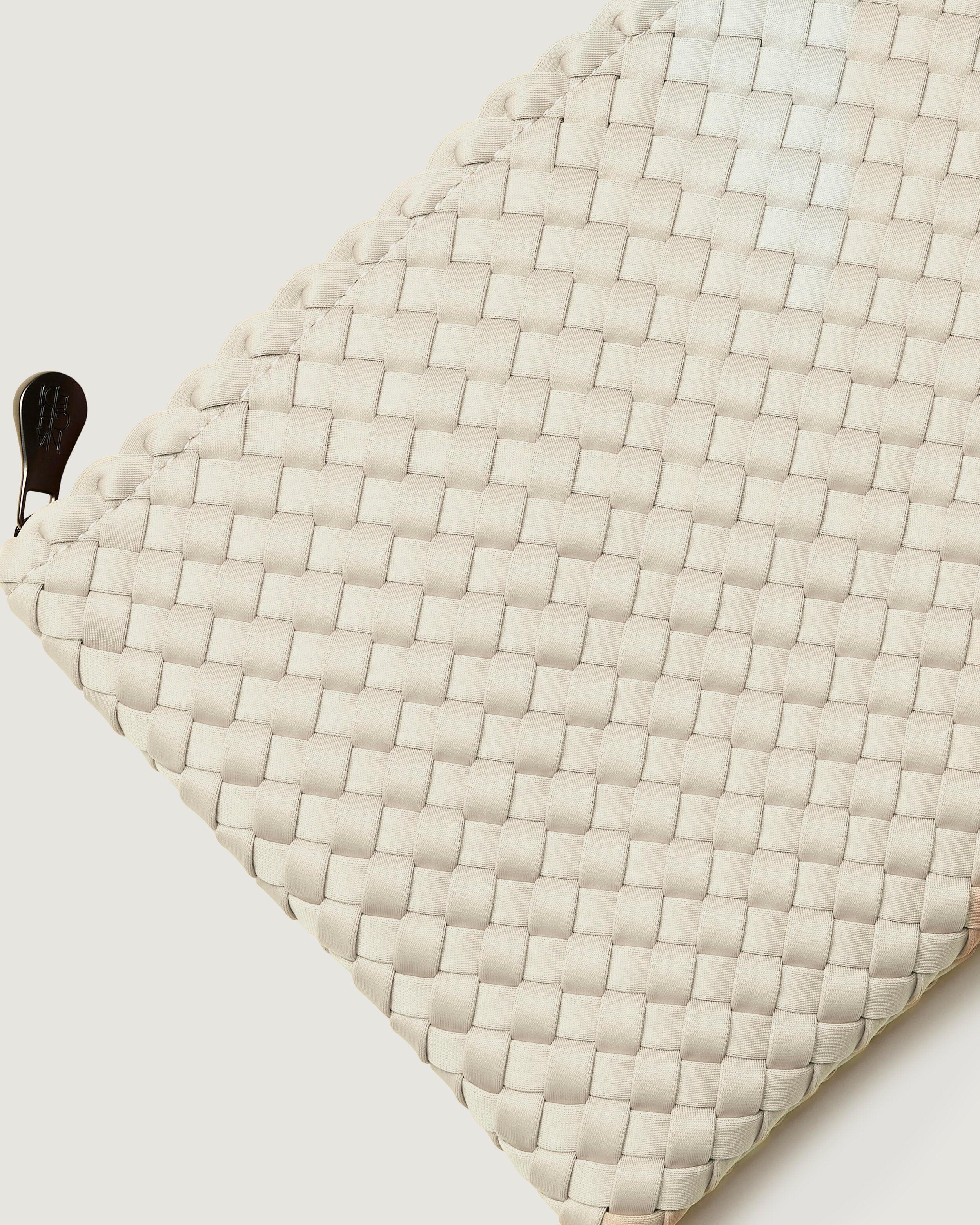 Close-up of included matching woven zippered pouch.