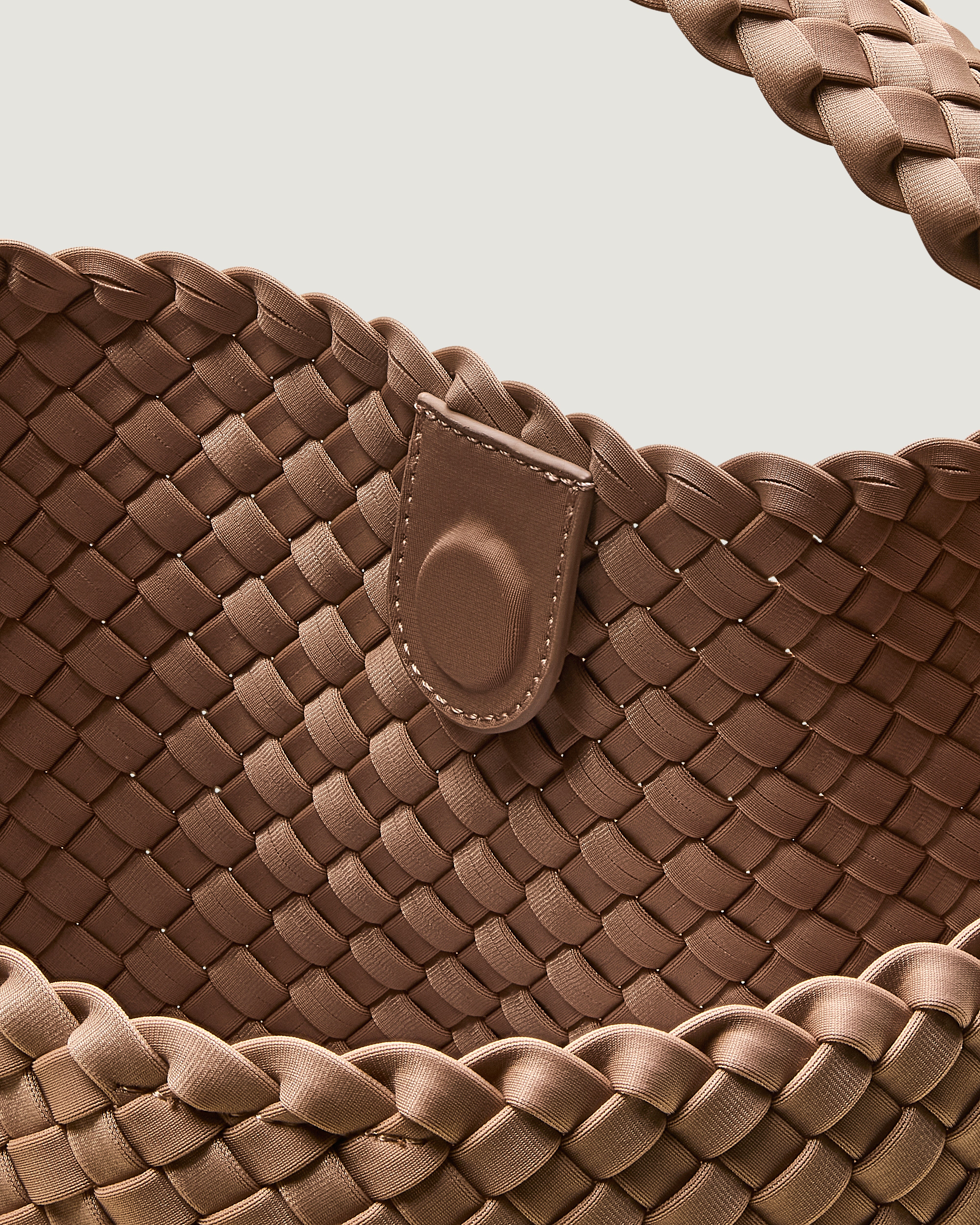 Interior close-up of Nomad Hobo in Seychelles showing its open top with magnetic snap closure, and unlined interior.