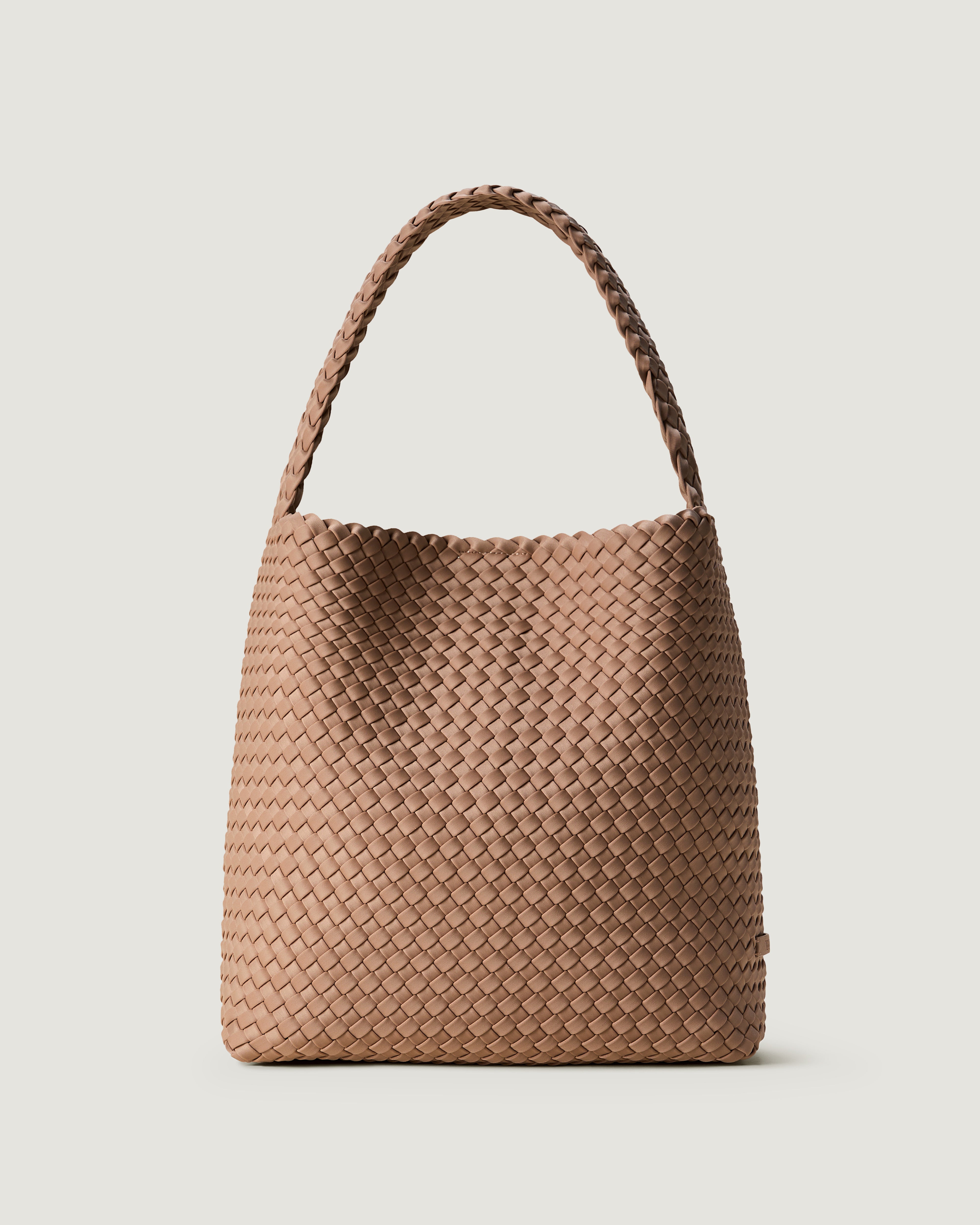 Nomad Hobo in Seychelles, a mocha tone, in handwoven neoprene, featuring an open top with magnetic snap closure, and handwoven shoulder strap lays comfortably flat.