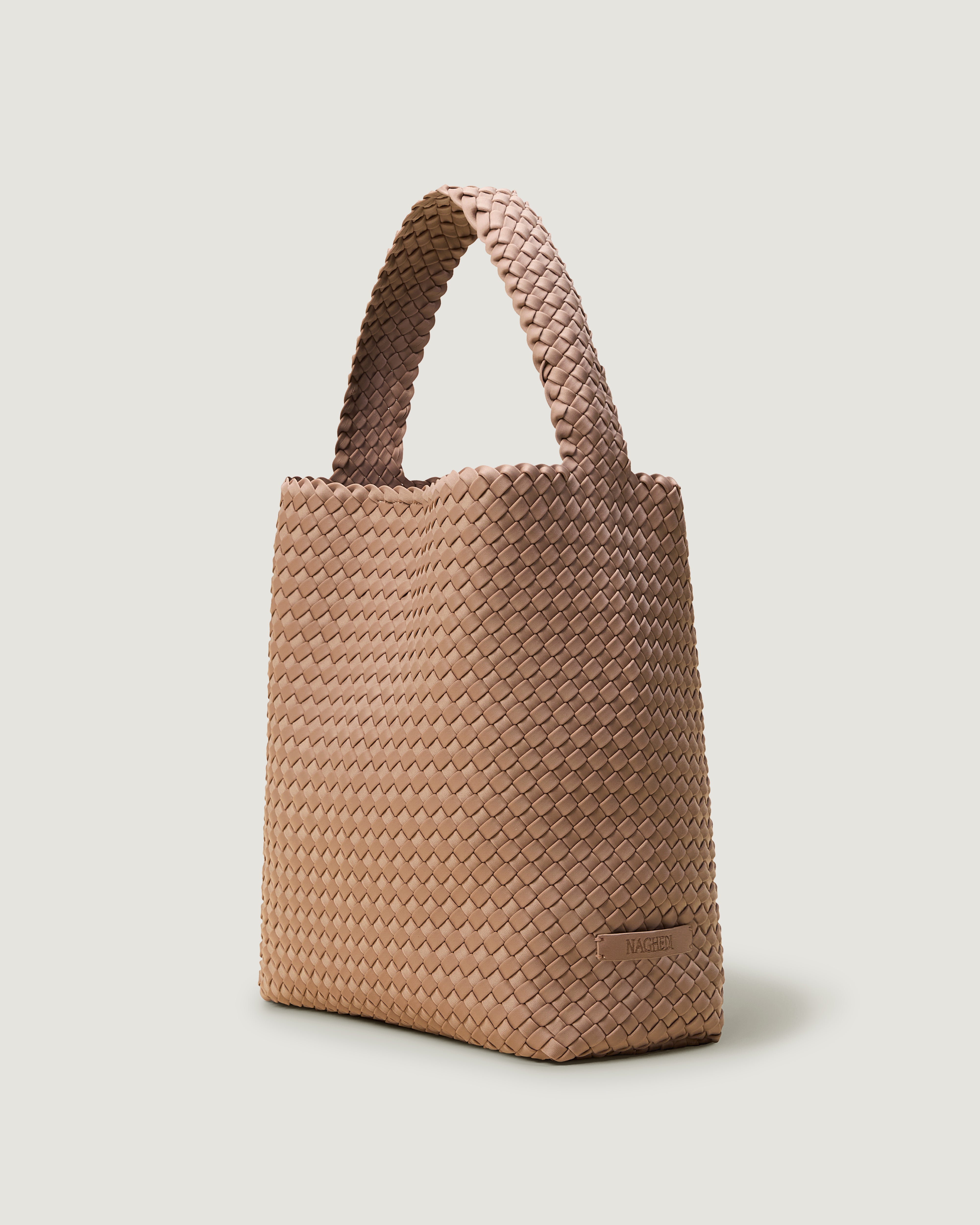 Nomad Hobo in Seychelles shown from a side angle, highlighting its handwoven neoprene construction and open top with magnetic snap closure.