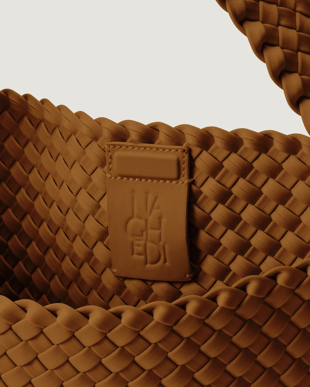 Interior close-up of Nomad Hobo in Teak showing its magnetic snap closure, and unlined interior.