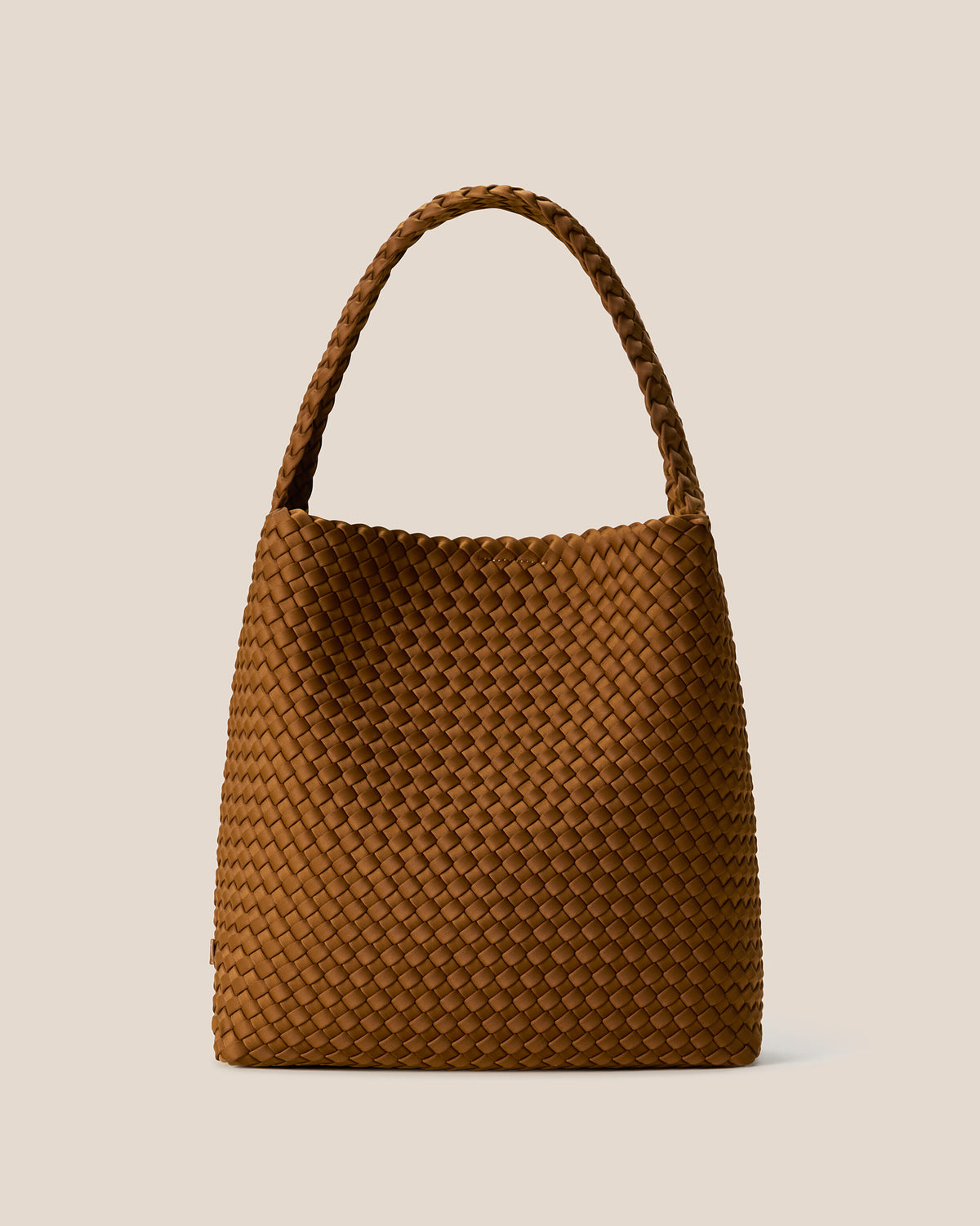 Nomad Hobo in Teak, a saddle brown tone, in handwoven neoprene, featuring an open top with magnetic snap closure, and handwoven shoulder strap lays comfortably flat.