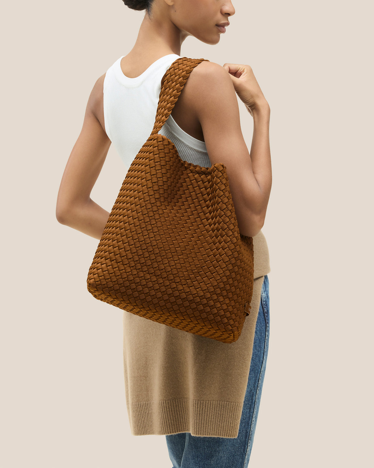 Nomad Hobo in Teak shown on model to illustrate scale and soft silhouette.