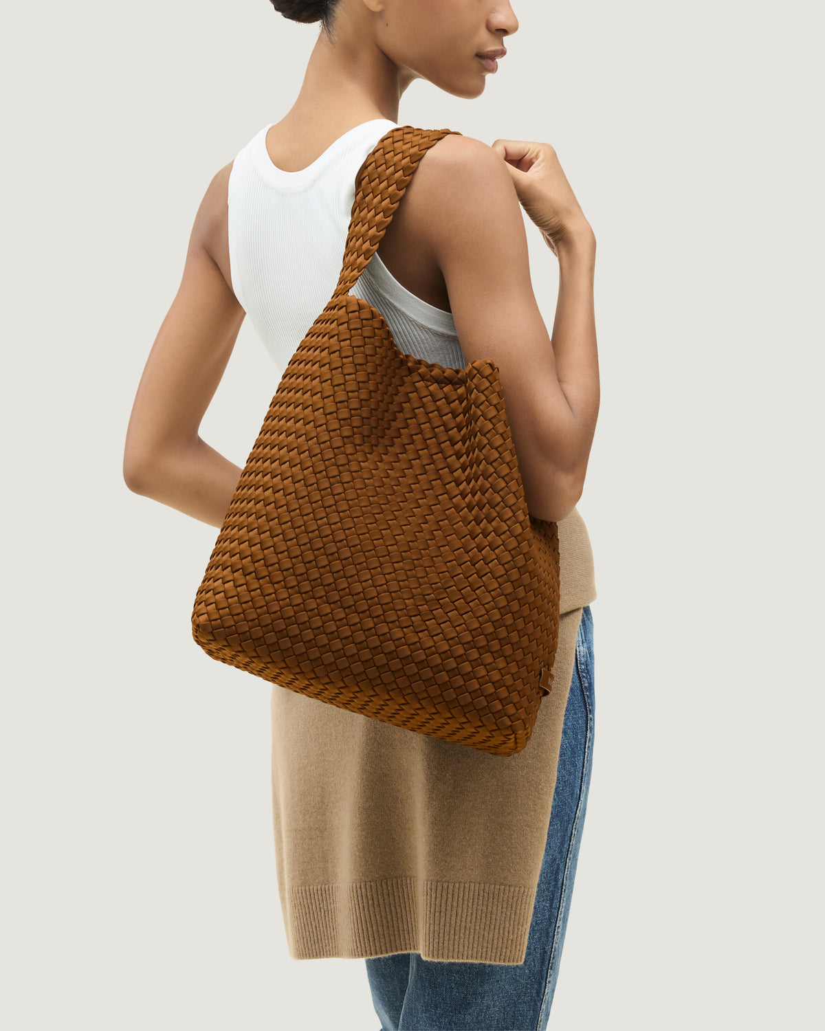 Nomad Hobo in Teak shown on model to illustrate scale and soft silhouette.