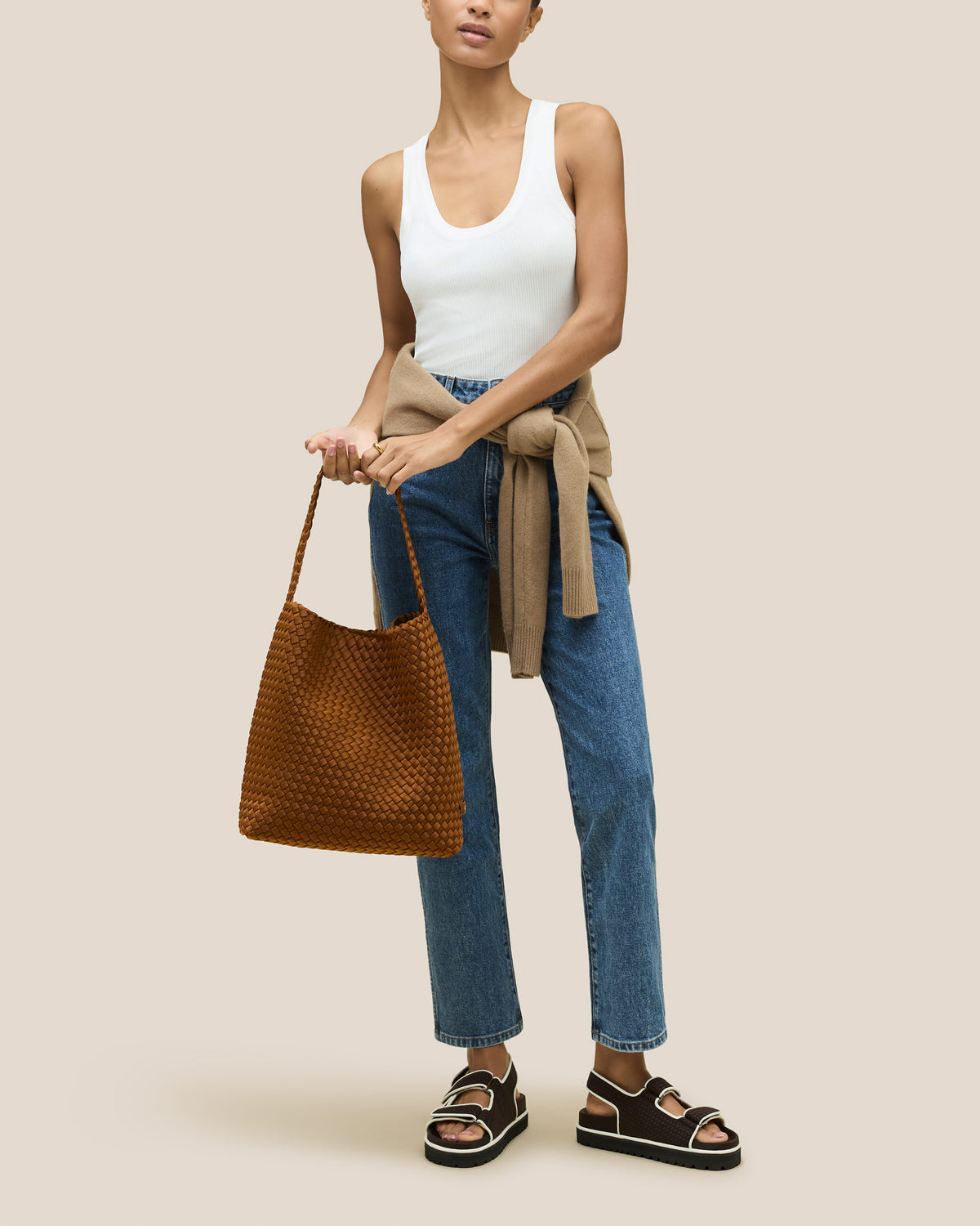 Nomad Hobo in Teak shown on model to illustrate scale and soft silhouette.