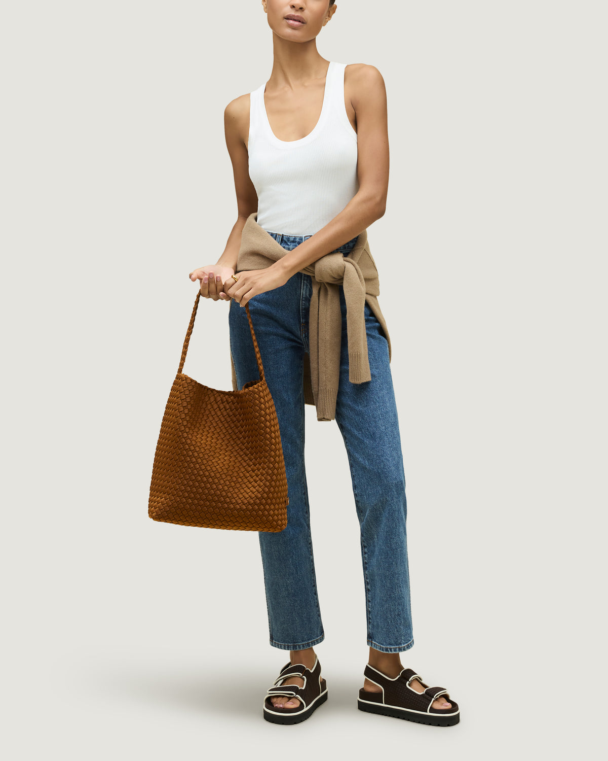 Nomad Hobo in Teak shown on model to illustrate scale and soft silhouette.