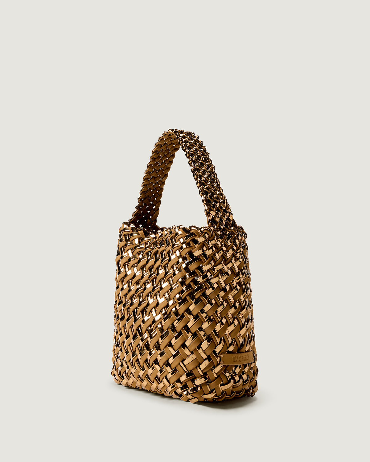 Nomad Small Hobo in Firenze shown from a side angle, highlighting its handwoven metallic coated nylon construction and open top with magnetic snap closure.