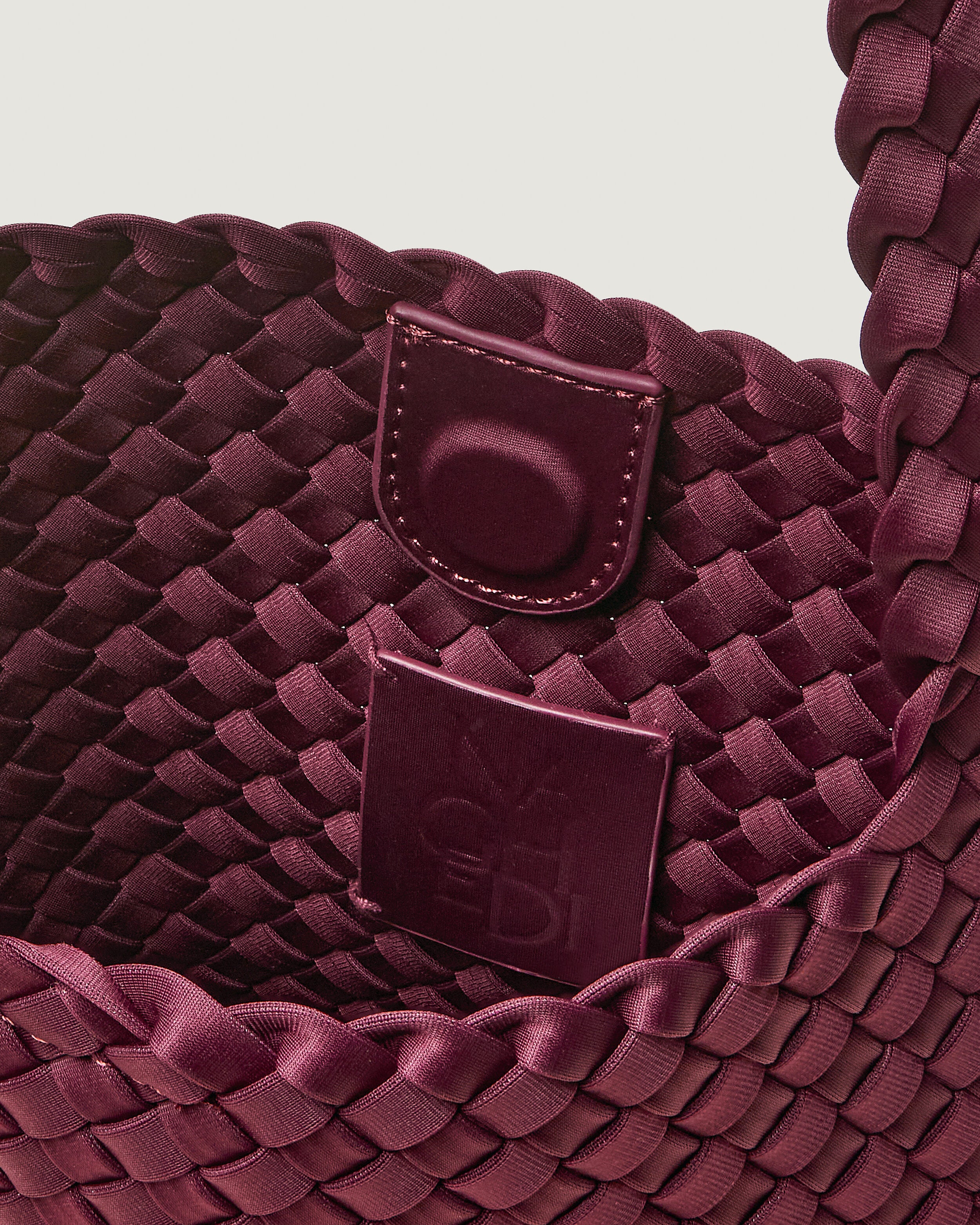 Interior close-up of Nomad Hobo in Bordeaux showing its open top with magnetic snap closure, and unlined interior.