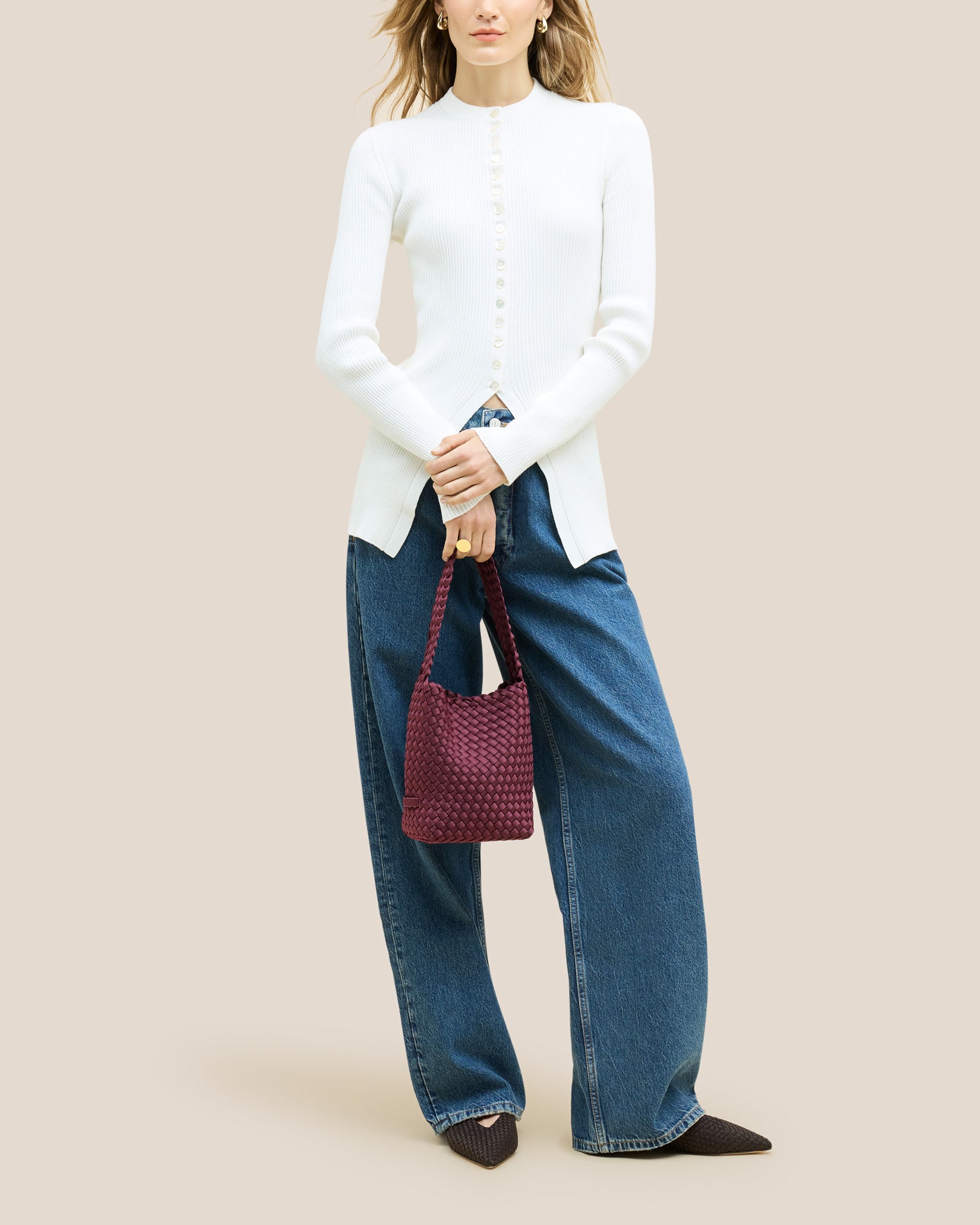 Nomad Small Hobo Bag in Bordeaux shown on model to illustrate scale and soft silhouette.