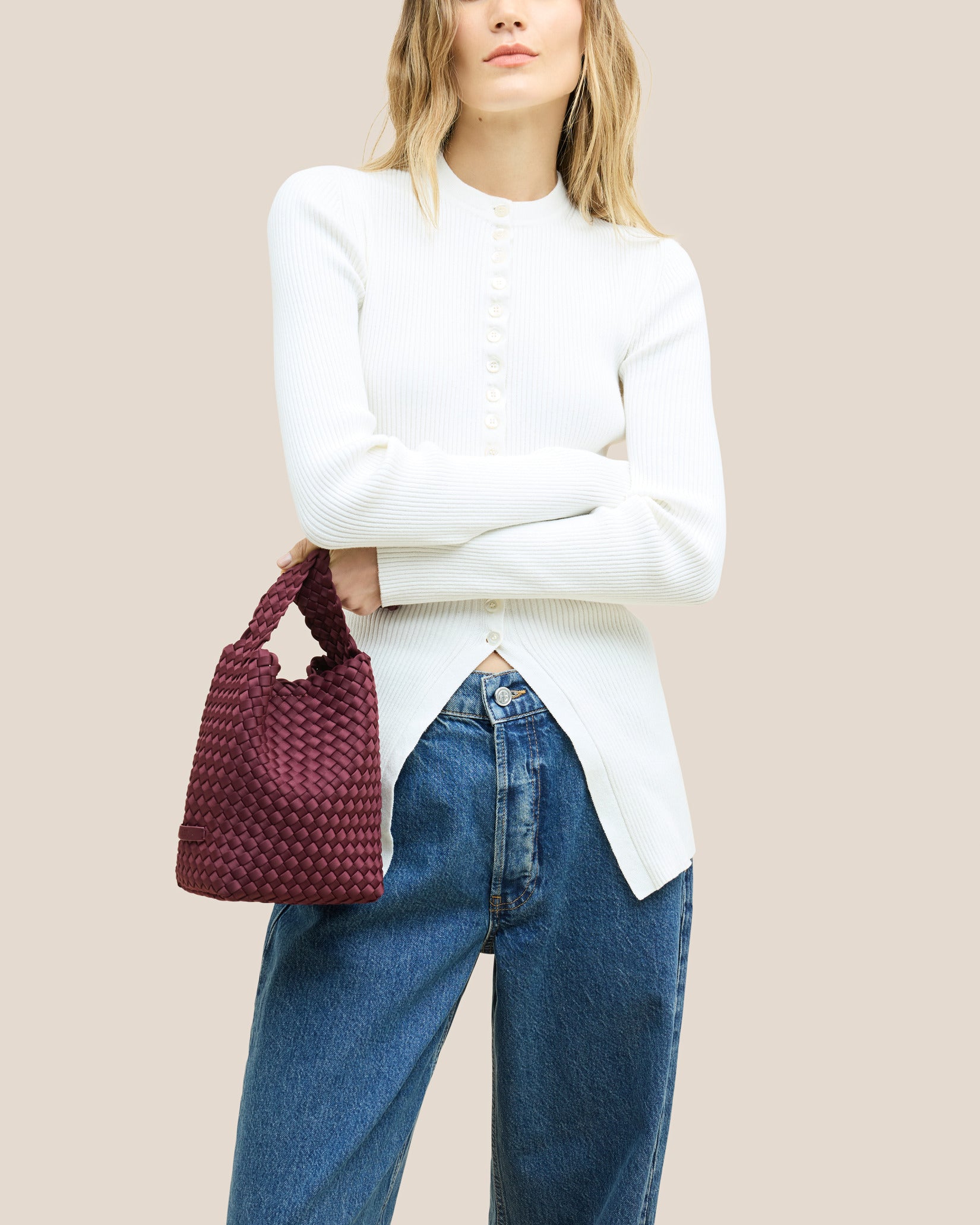 Nomad Small Hobo Bag in Bordeaux shown on model to illustrate scale and soft silhouette.