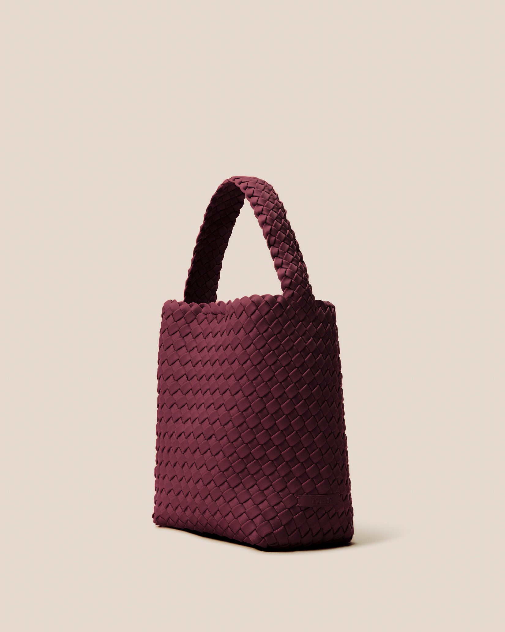 Nomad Small Hobo Bag in Bordeaux shown from a side angle, highlighting its handwoven neoprene and open top with magnetic snap closure.