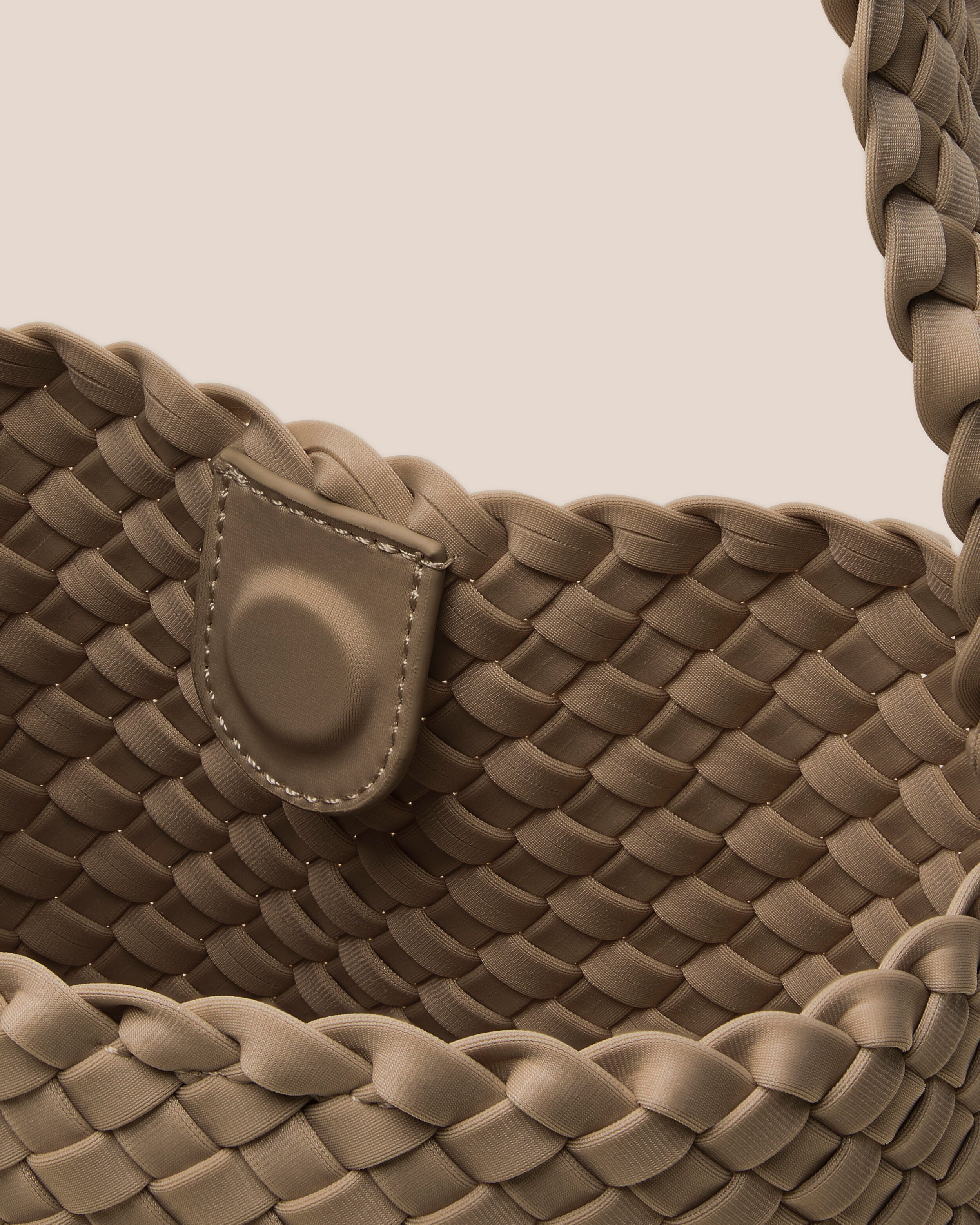 Interior close-up of Nomad Hobo in Cashmere showing its open top with magnetic snap closure, and unlined interior.