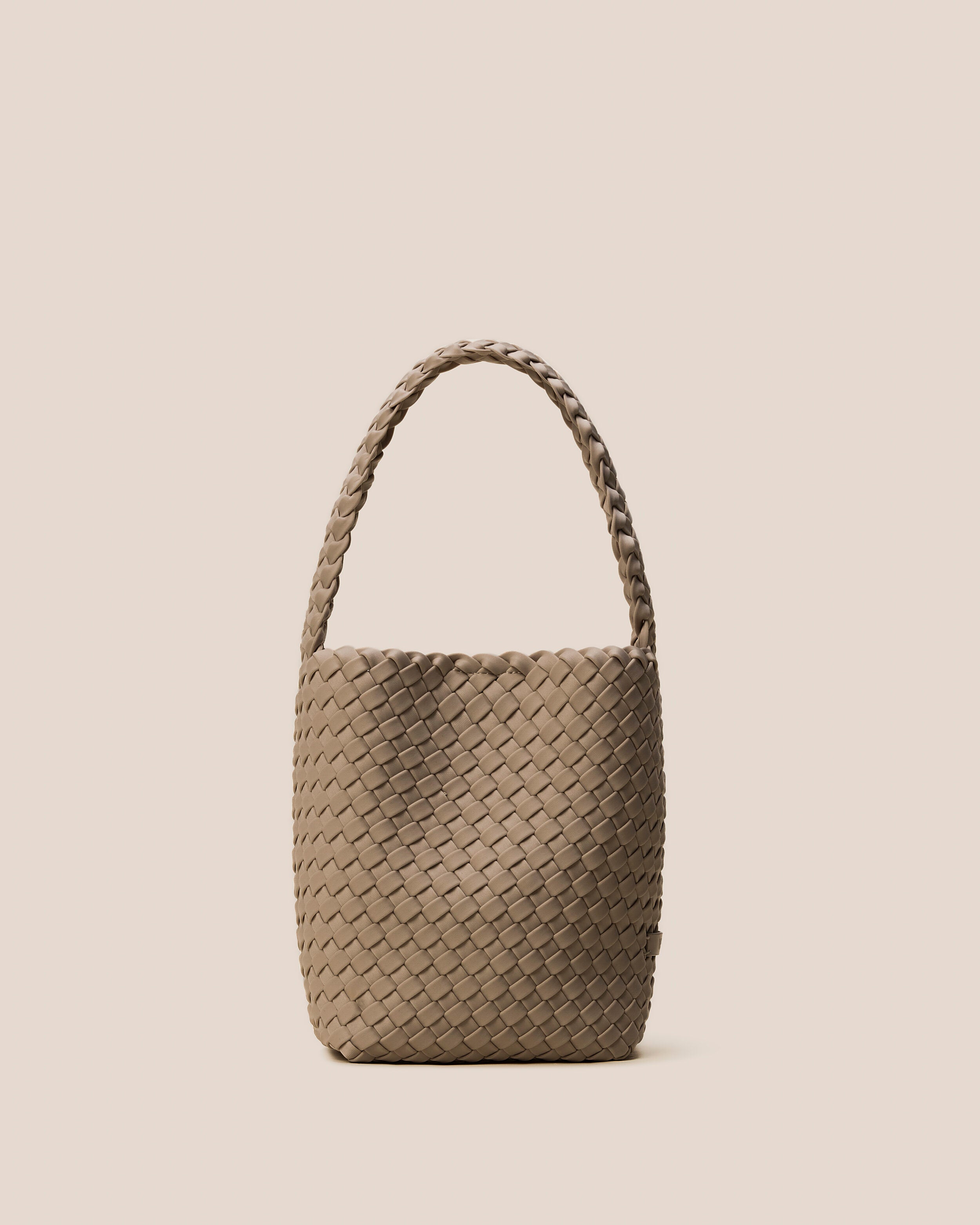 Nomad Hobo in Cashmere, a taupe tone, in handwoven neoprene, featuring an open top with magnetic snap closure, and handwoven shoulder strap lays comfortably flat.