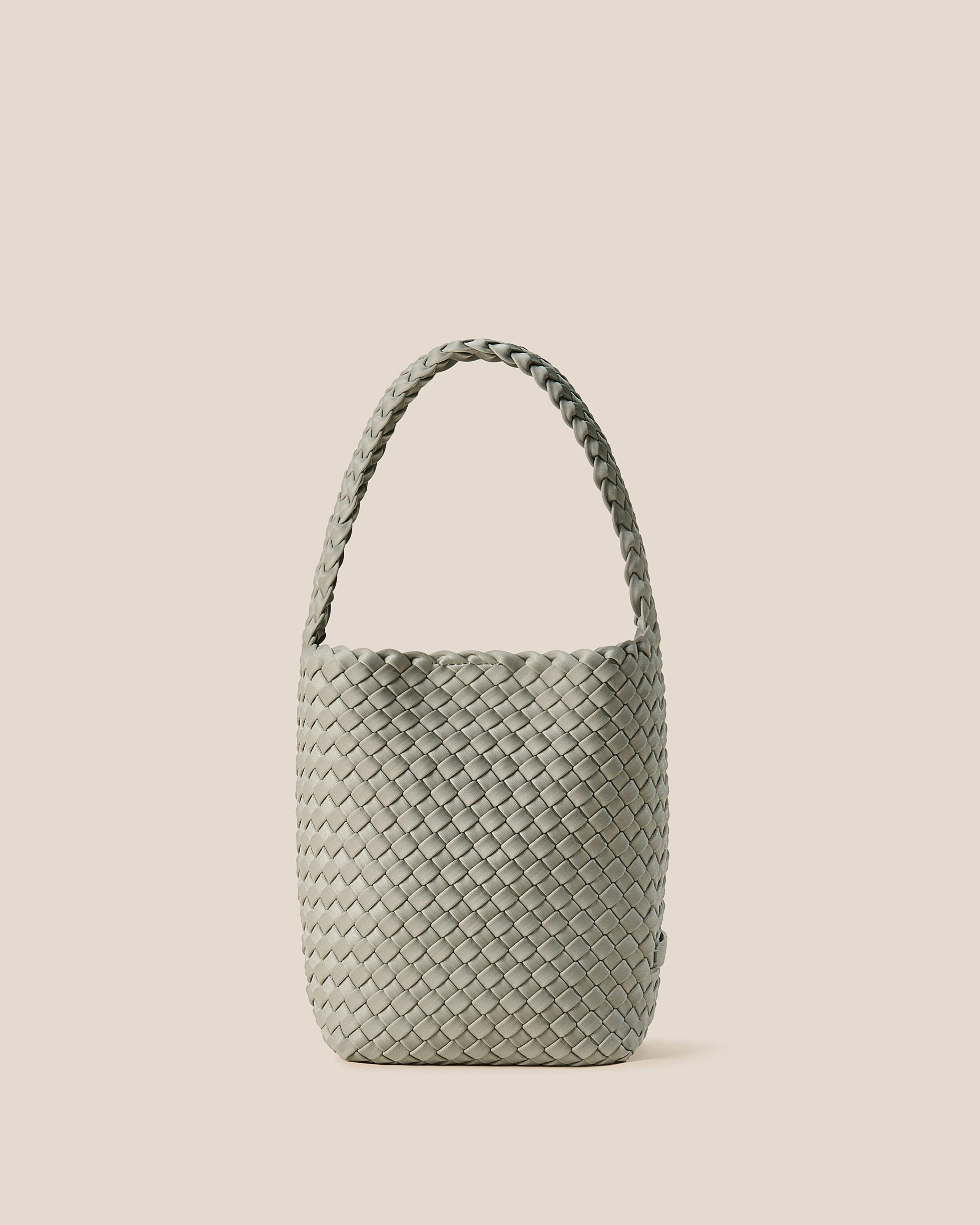 Nomad Hobo in Celadon, a light jade green tone, in handwoven neoprene, featuring an open top with magnetic snap closure, and handwoven shoulder strap lays comfortably flat.