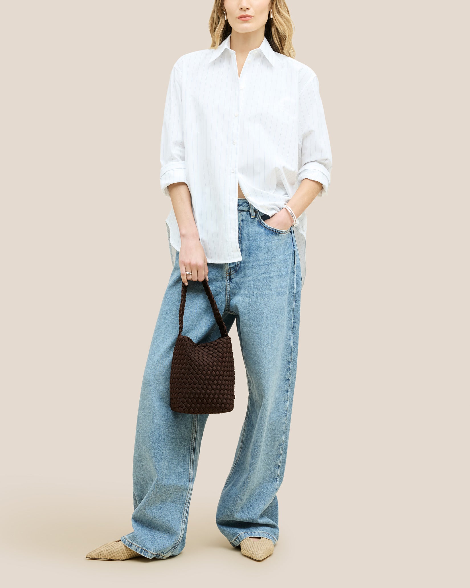 Nomad Small Hobo Bag in Chocolate shown on model to illustrate scale and soft silhouette.