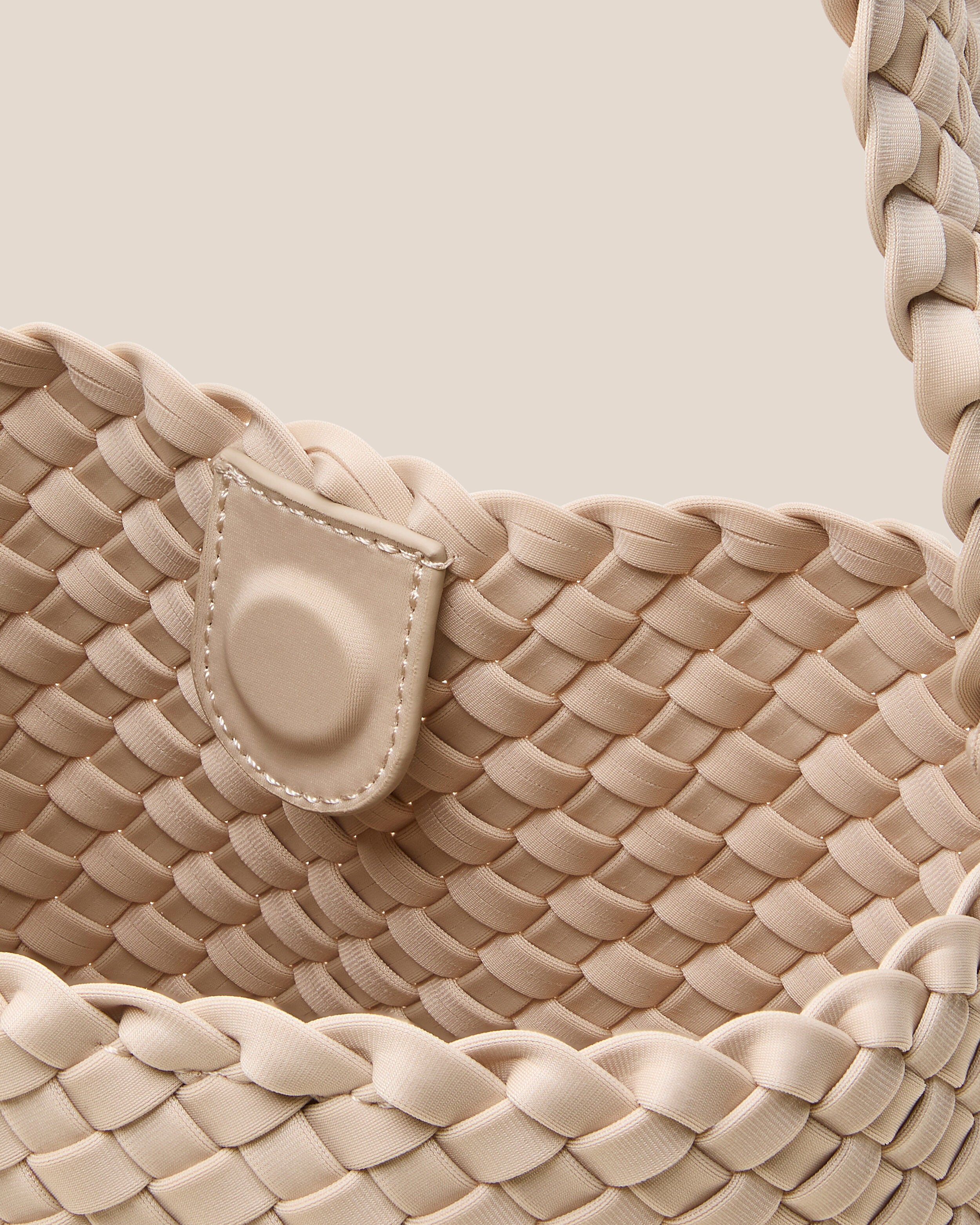 Interior close-up of Nomad Hobo in Ecru showing its open top with magnetic snap closure, and unlined interior.