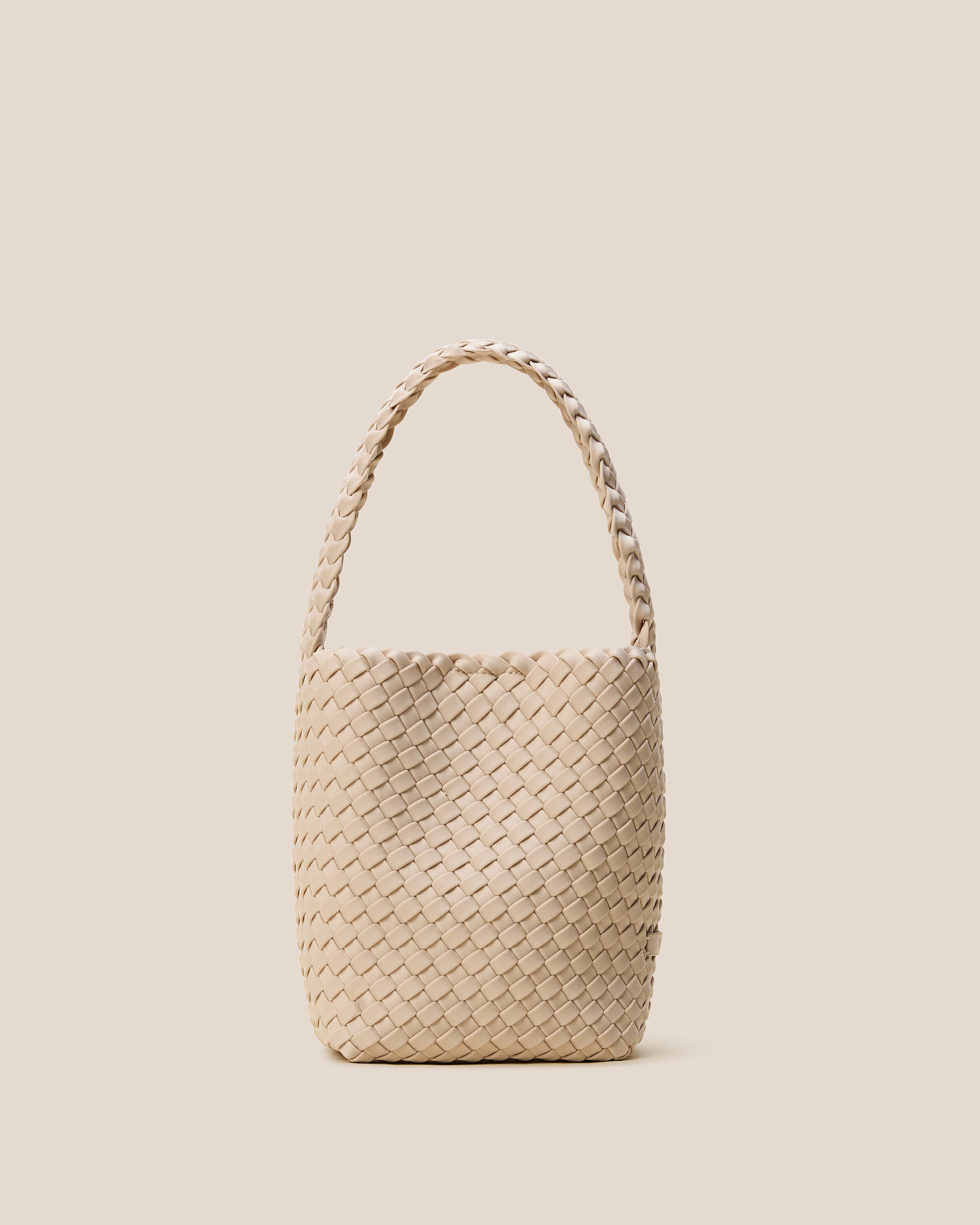 Nomad Hobo in Ecru, a cream tone, in handwoven neoprene, featuring an open top with magnetic snap closure, and handwoven shoulder strap lays comfortably flat.