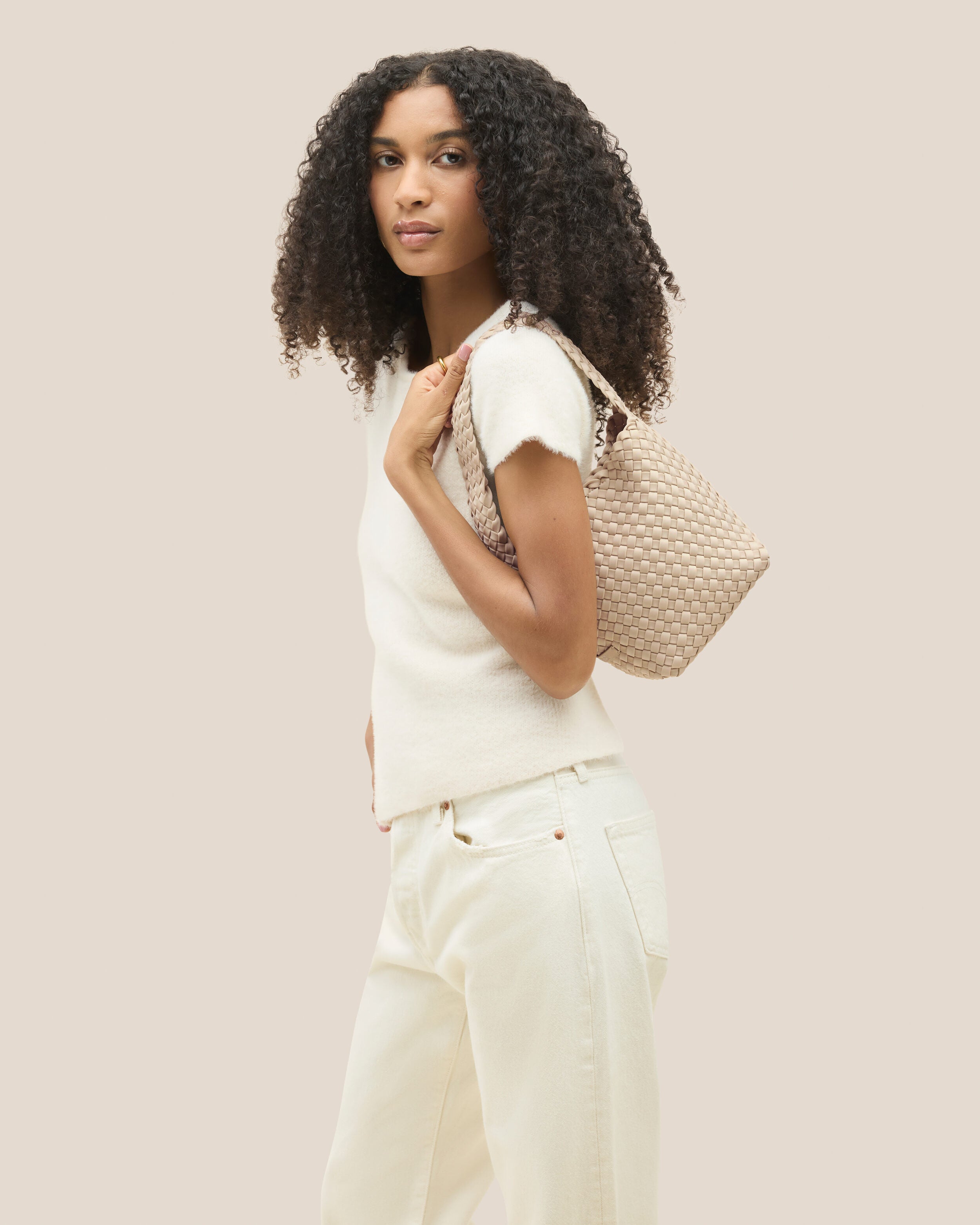 Nomad Hobo in Ecru shown on model to illustrate scale and soft silhouette.