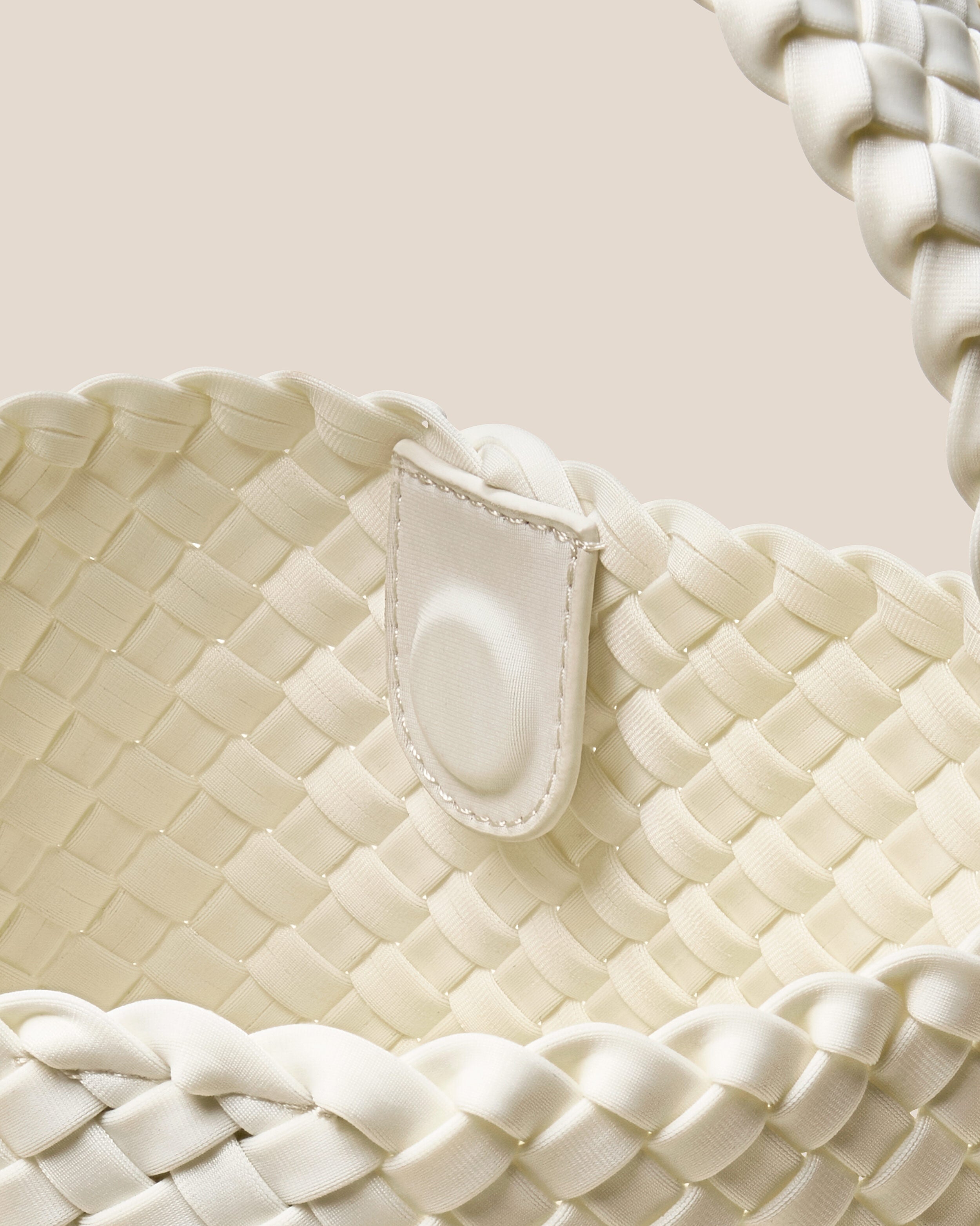 Interior close-up of Nomad Hobo in Jasmine showing its open top with magnetic snap closure, and unlined interior.