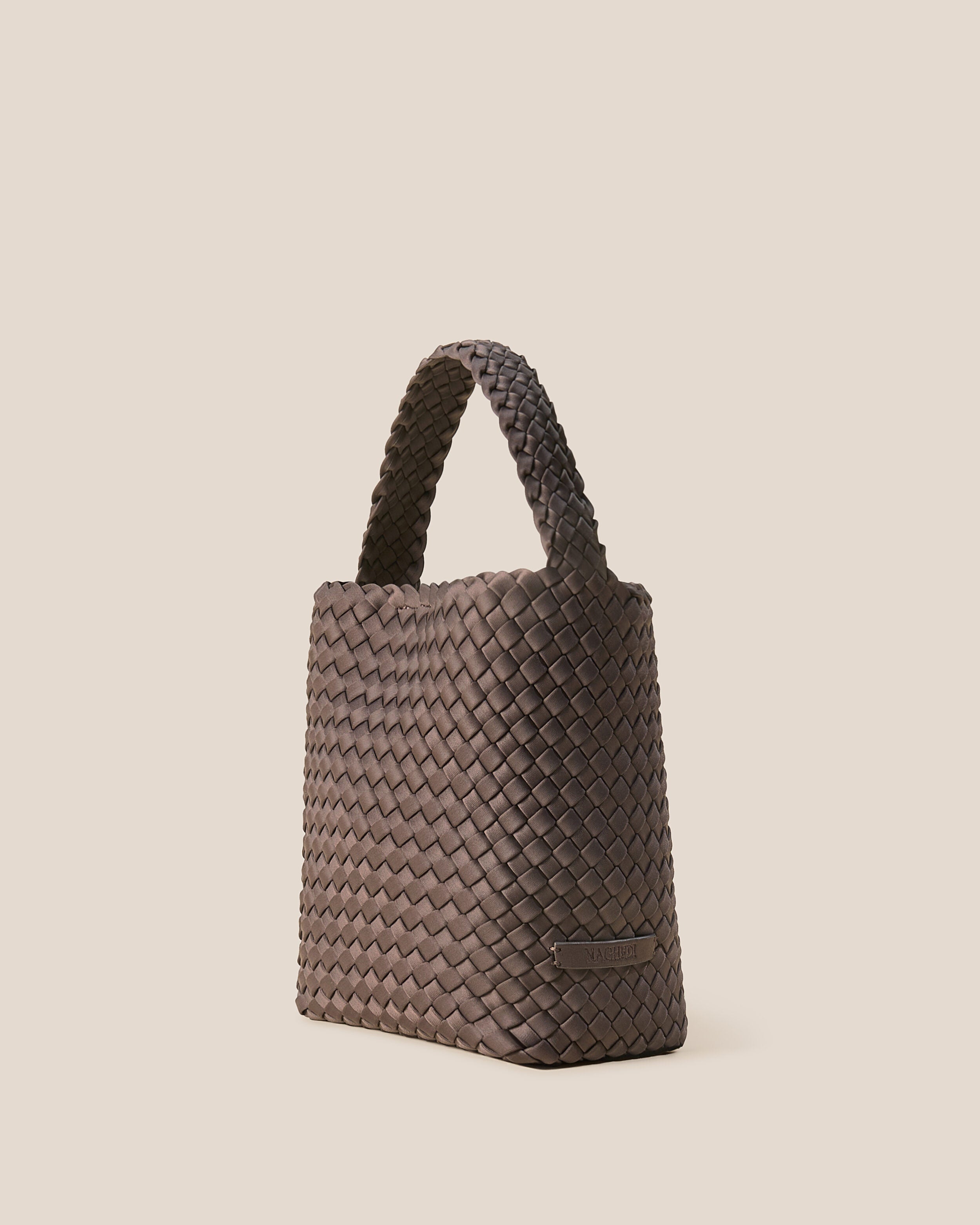 Nomad Hobo in Napa shown from a side angle, highlighting its handwoven neoprene construction and open top with magnetic snap closure.