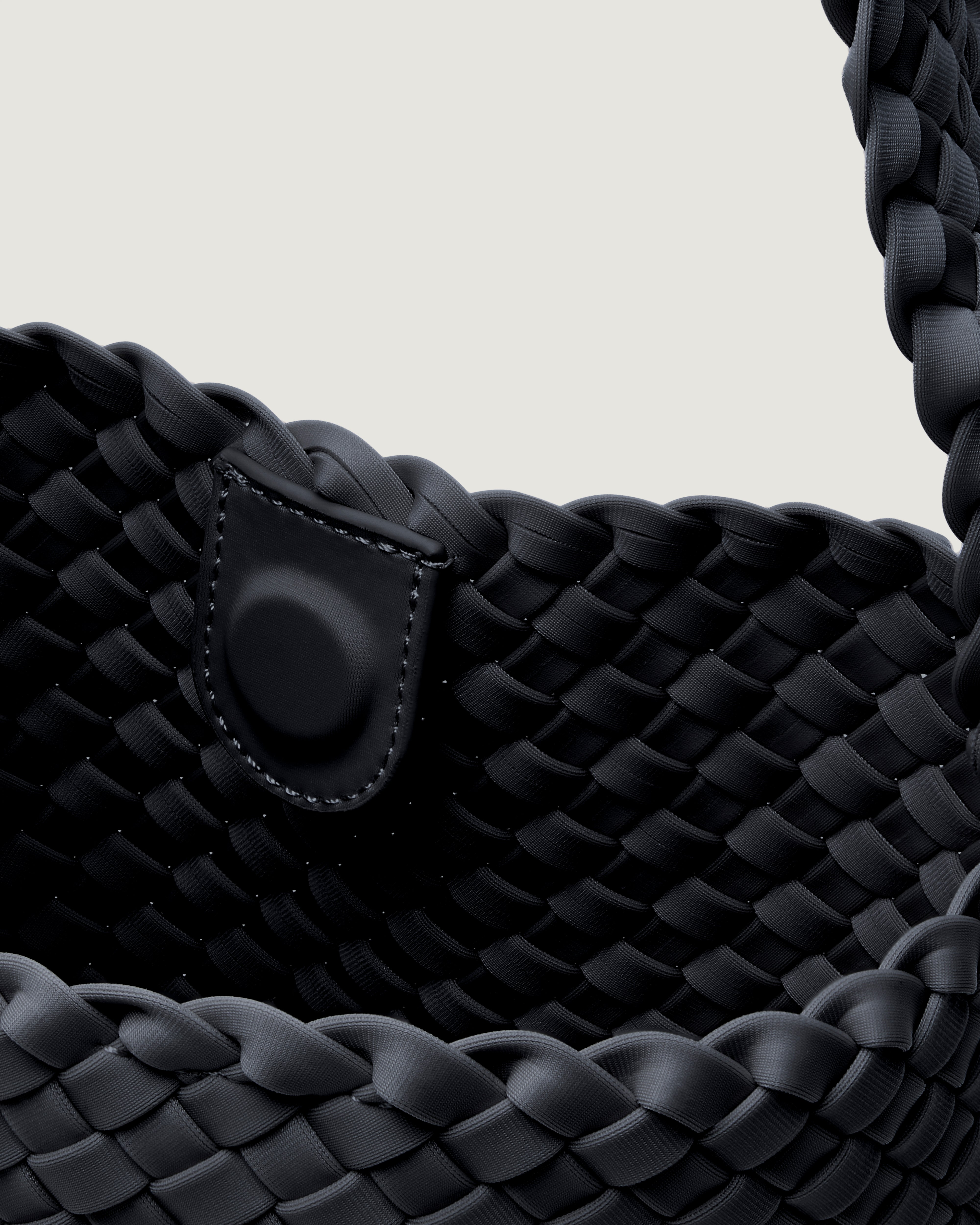 Interior close-up of Nomad Hobo in Onyx showing its open top with magnetic snap closure, and unlined interior.