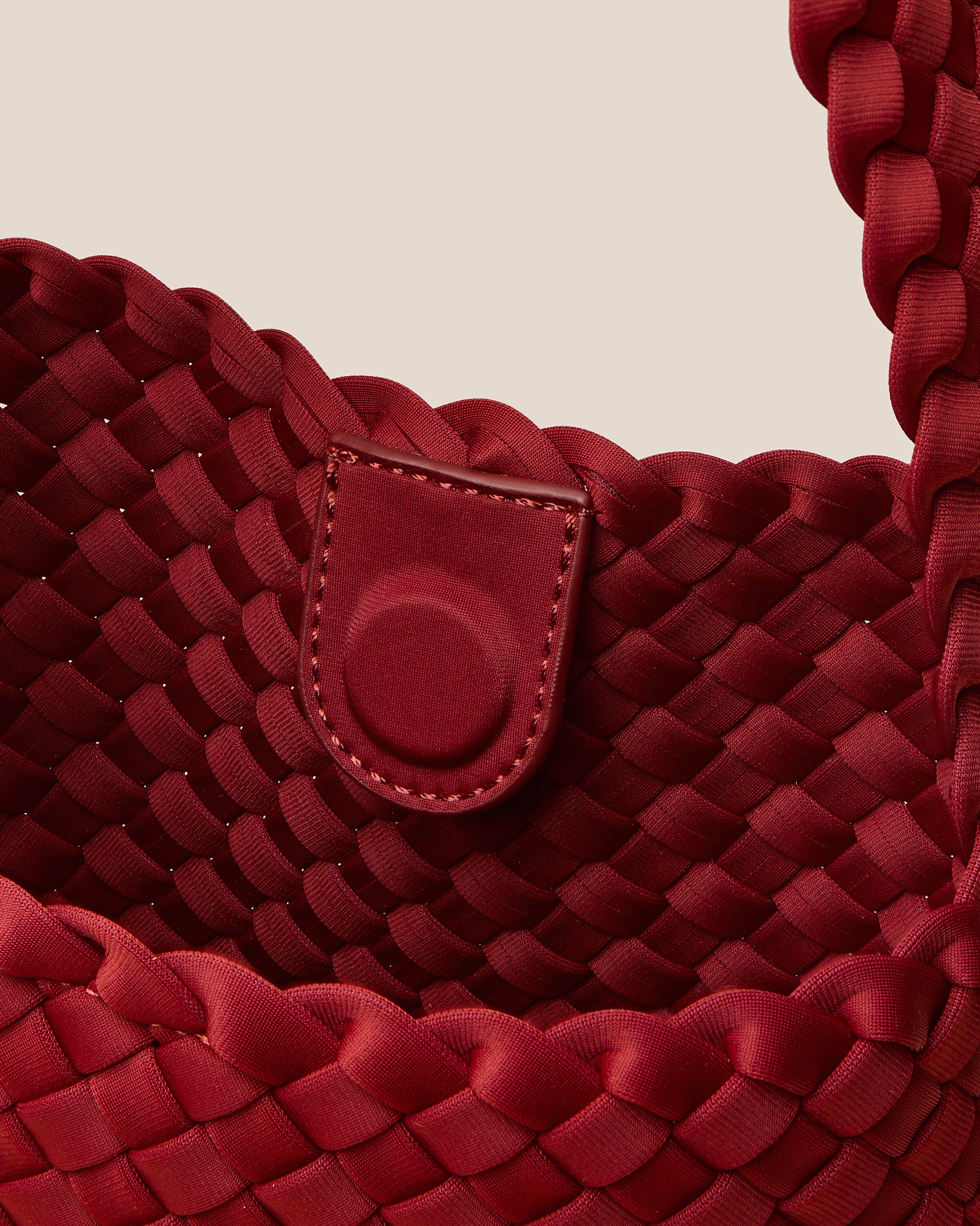Interior close-up of Nomad Hobo in Rosso showing its open top with magnetic snap closure, and unlined interior.