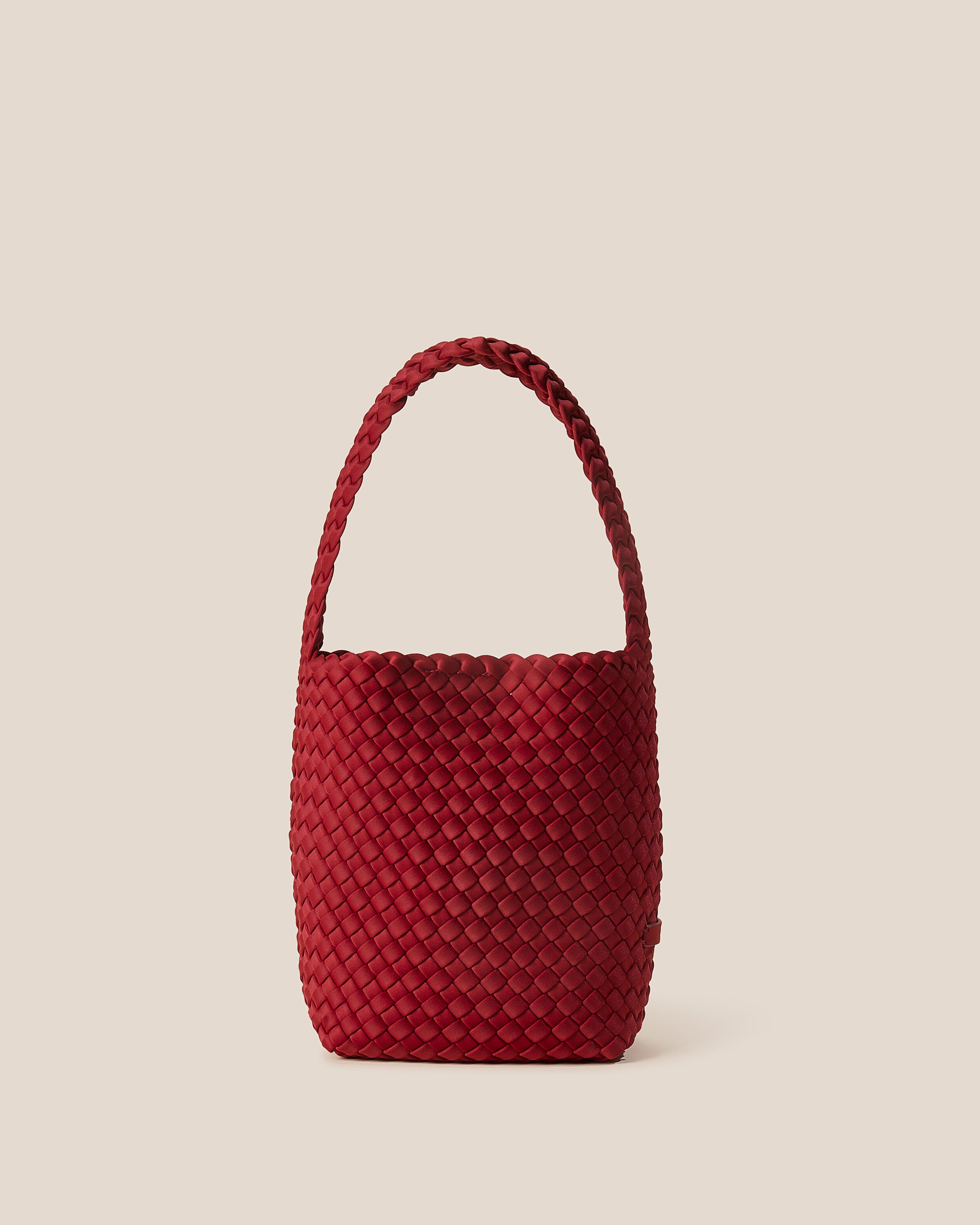Nomad Hobo in Rosso, a rich red tone, in handwoven neoprene, featuring an open top with magnetic snap closure, and handwoven shoulder strap lays comfortably flat.
