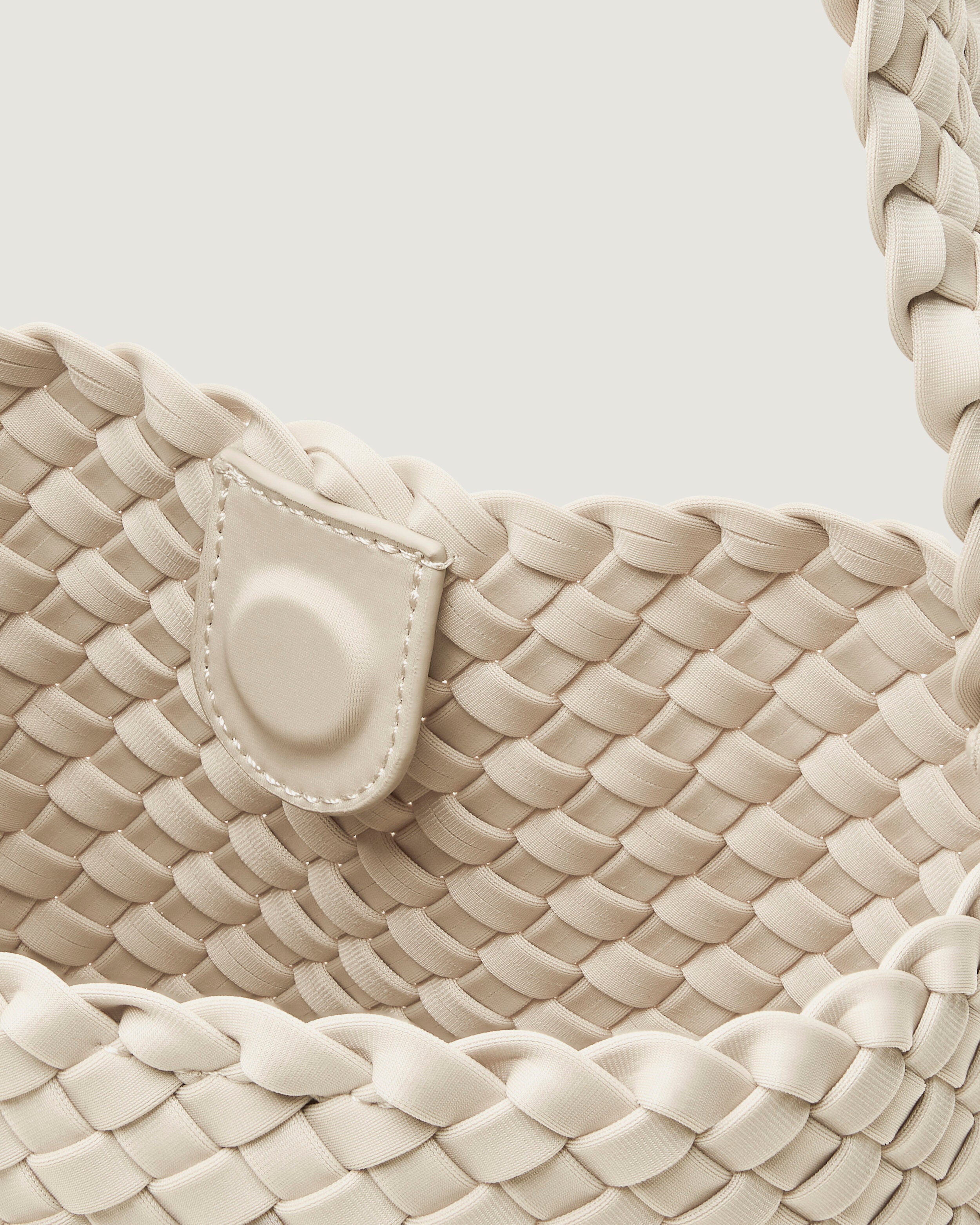 Interior close-up of Nomad Hobo in Salt showing its open top with magnetic snap closure, and unlined interior.