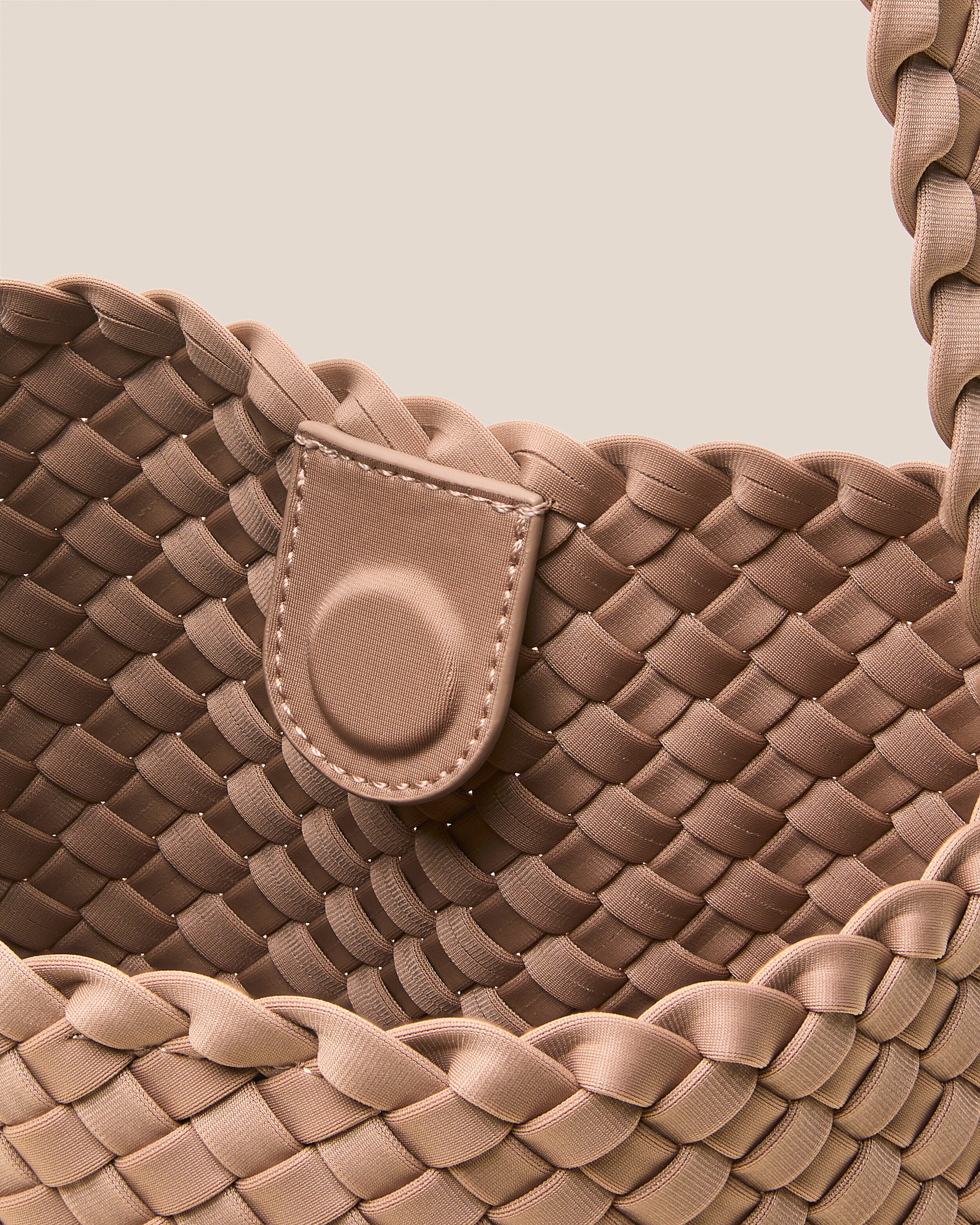 Interior close-up of Nomad Hobo in Seychelles showing its open top with magnetic snap closure, and unlined interior.